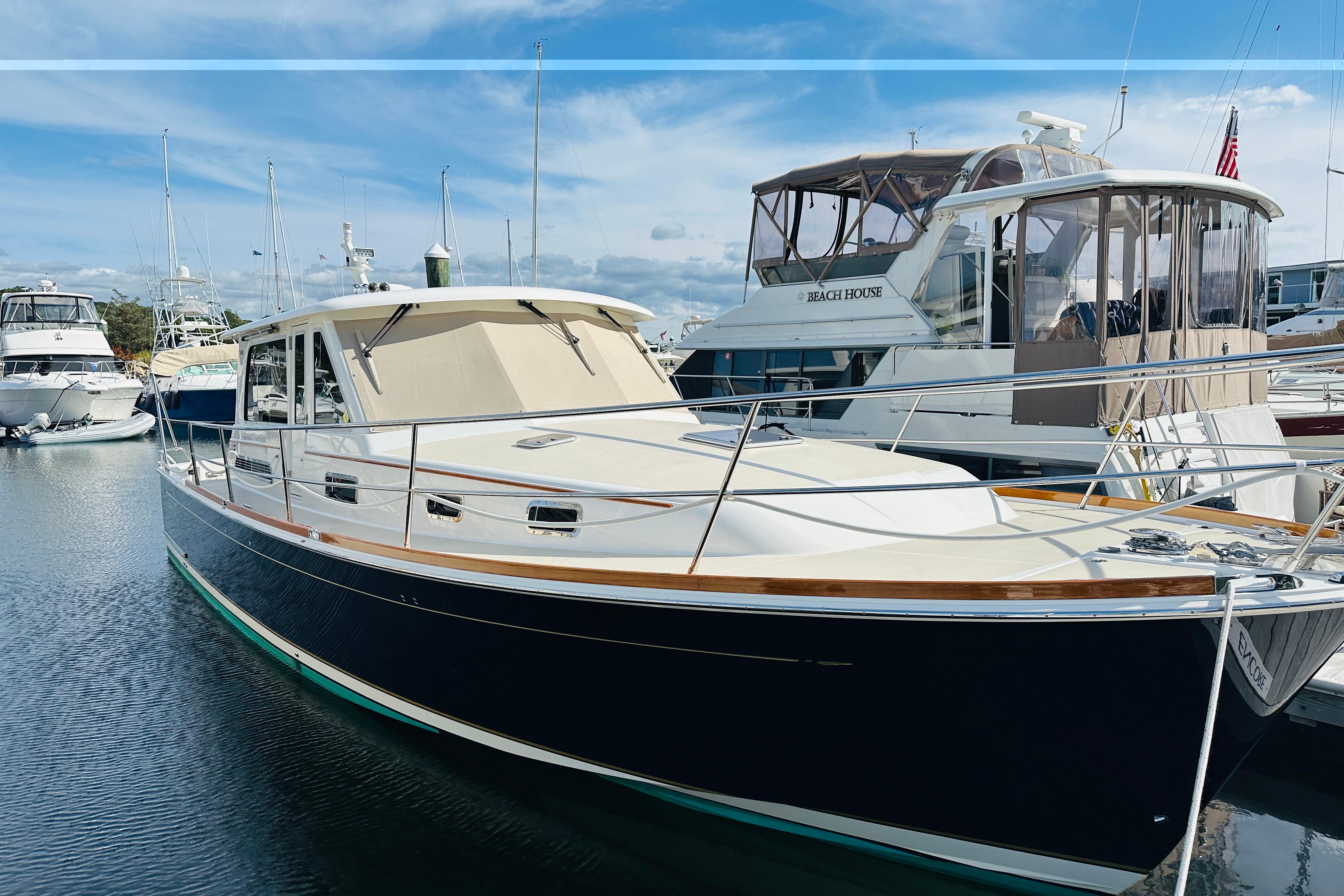 2017 Sabre 42 Salon Express yacht docked in marina under blue sky.