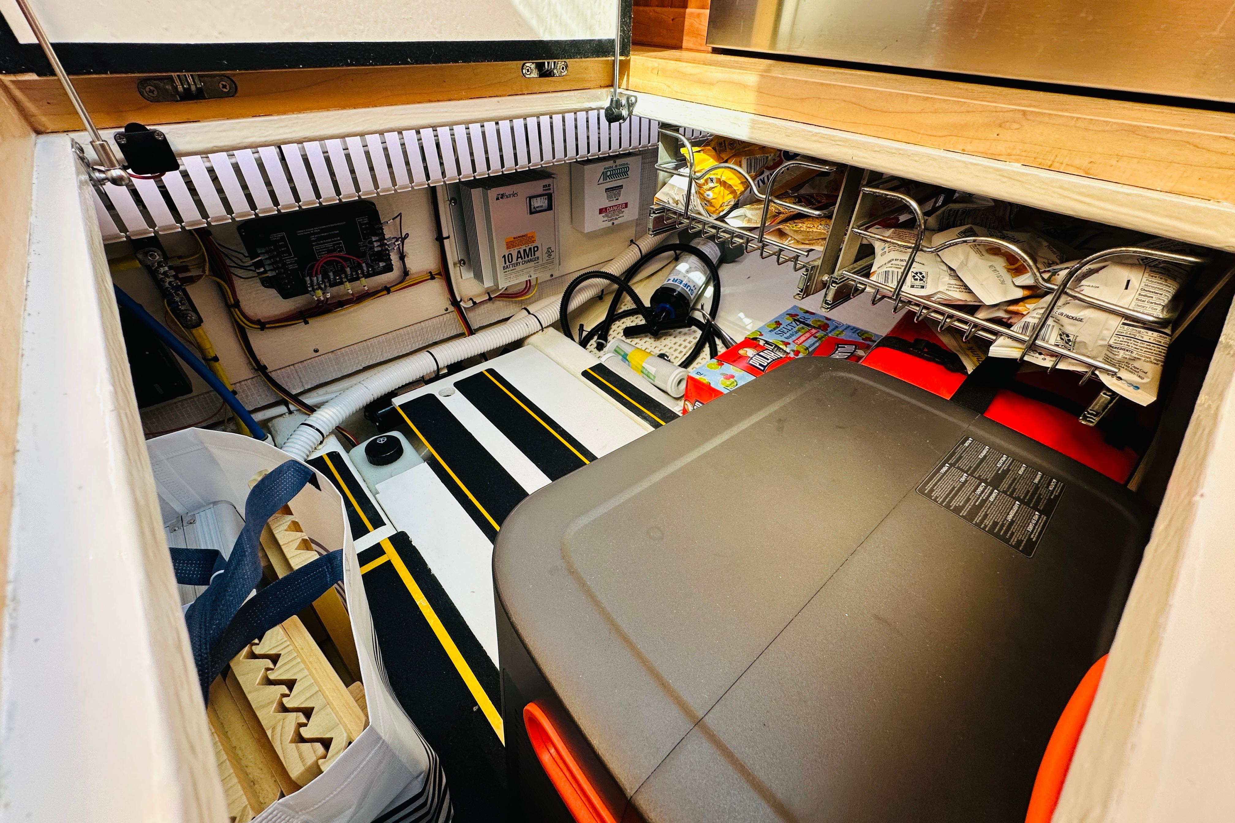 2017 Sabre 42 Salon Express storage area with organized supplies and electrical components.