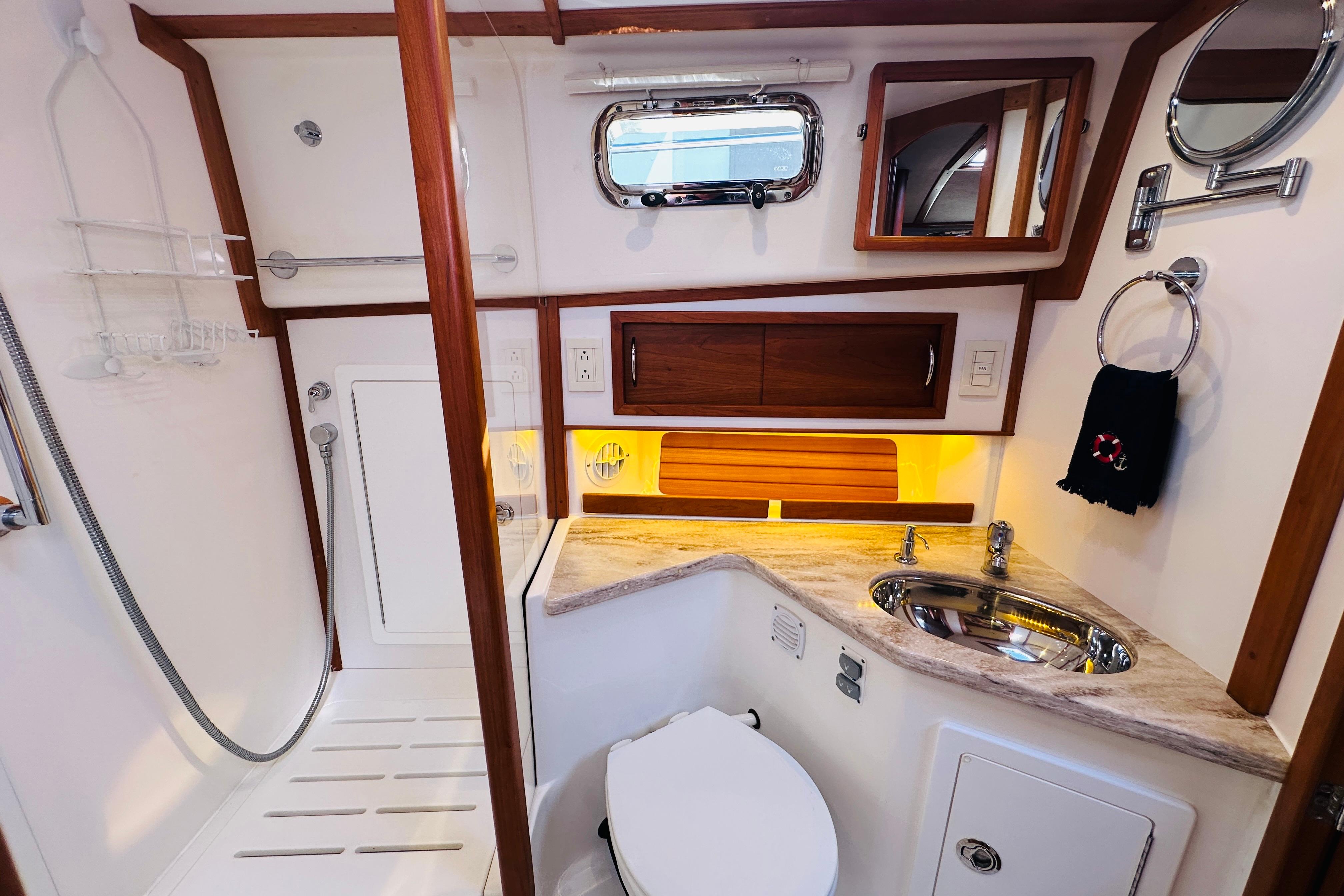 2017 Sabre 42 Salon Express bathroom with modern fixtures and wooden accents.