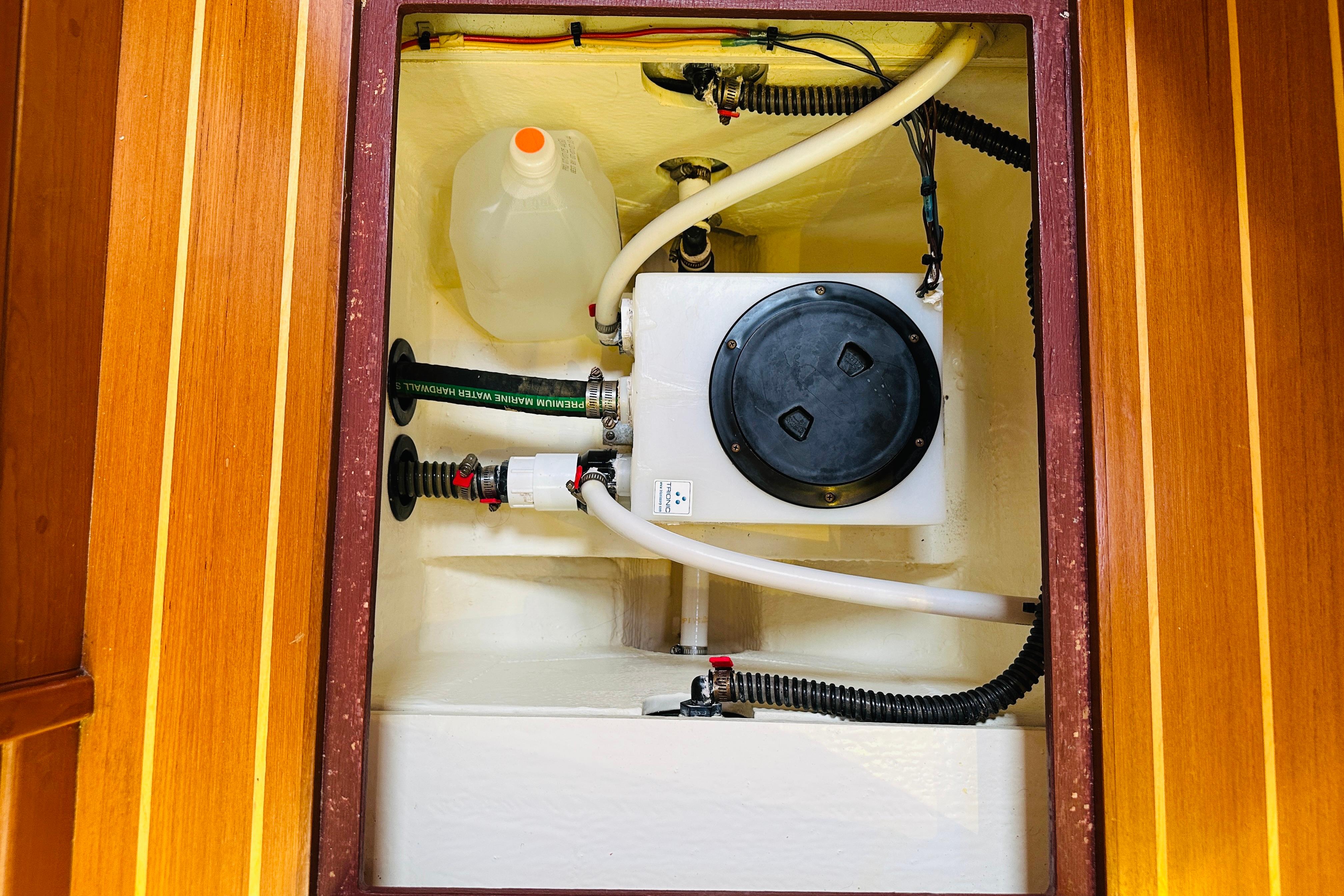 Engine compartment of 2017 Sabre 42 Salon Express with hoses and container.
