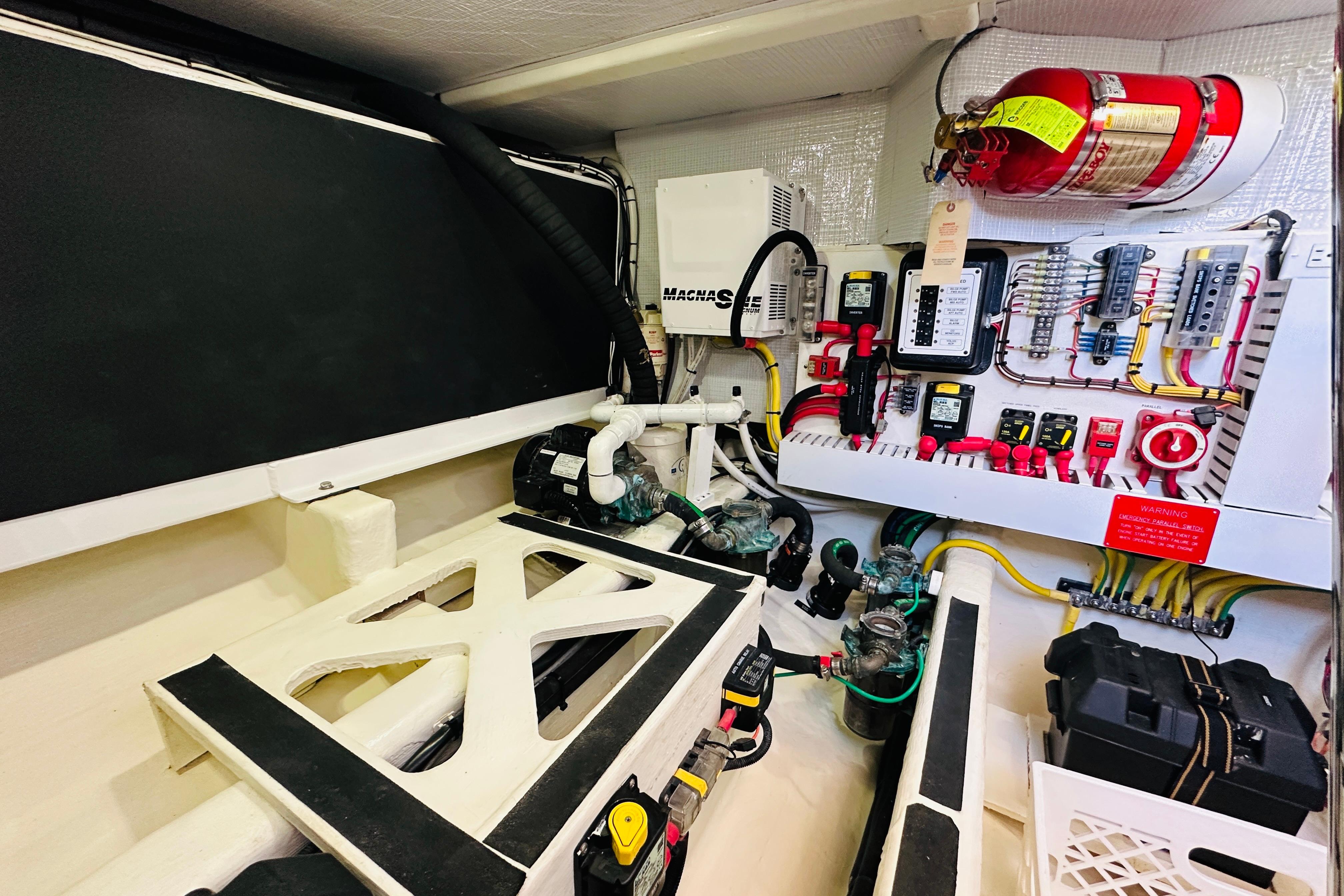 Engine room of 2017 Sabre 42 Salon Express with electrical panels and fire extinguisher.