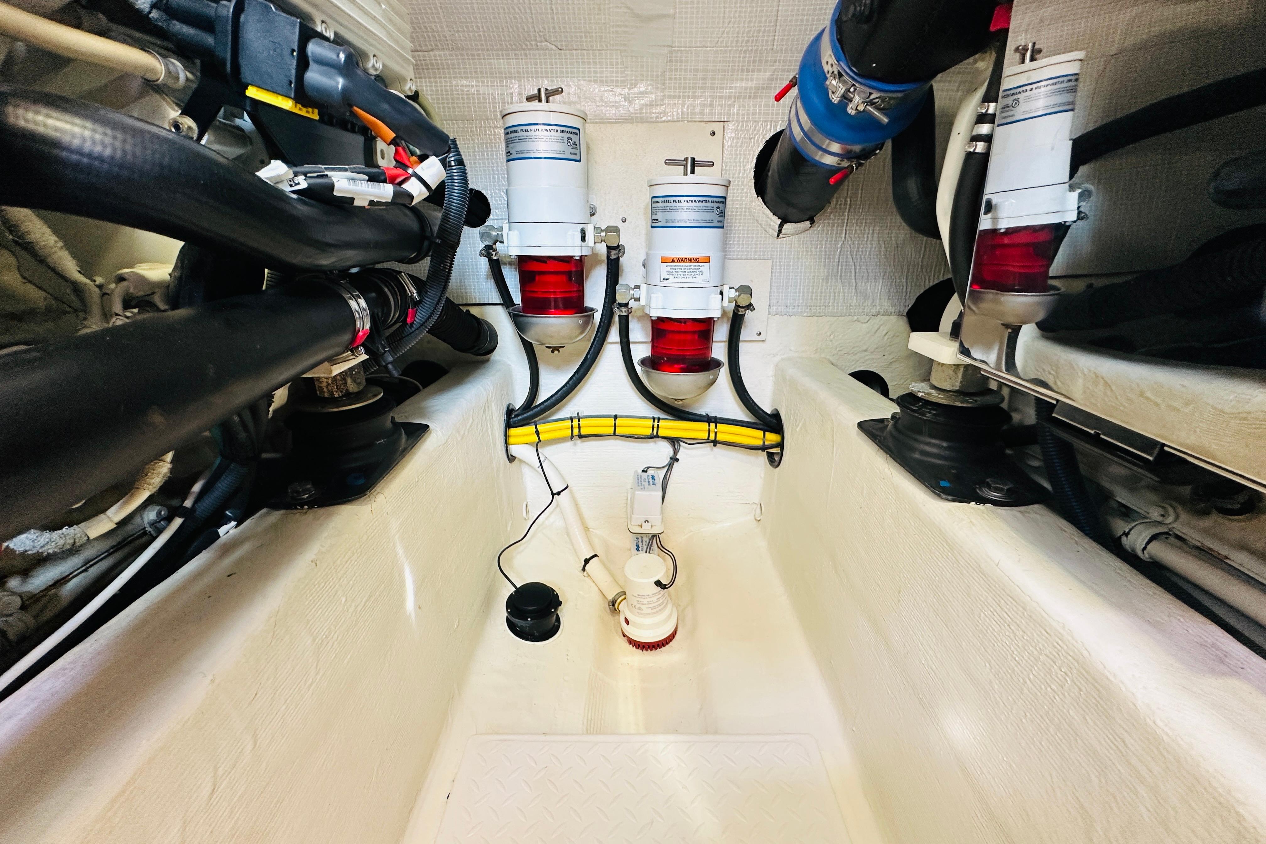 Engine room of 2017 Sabre 42 Salon Express with fuel filters and hoses.