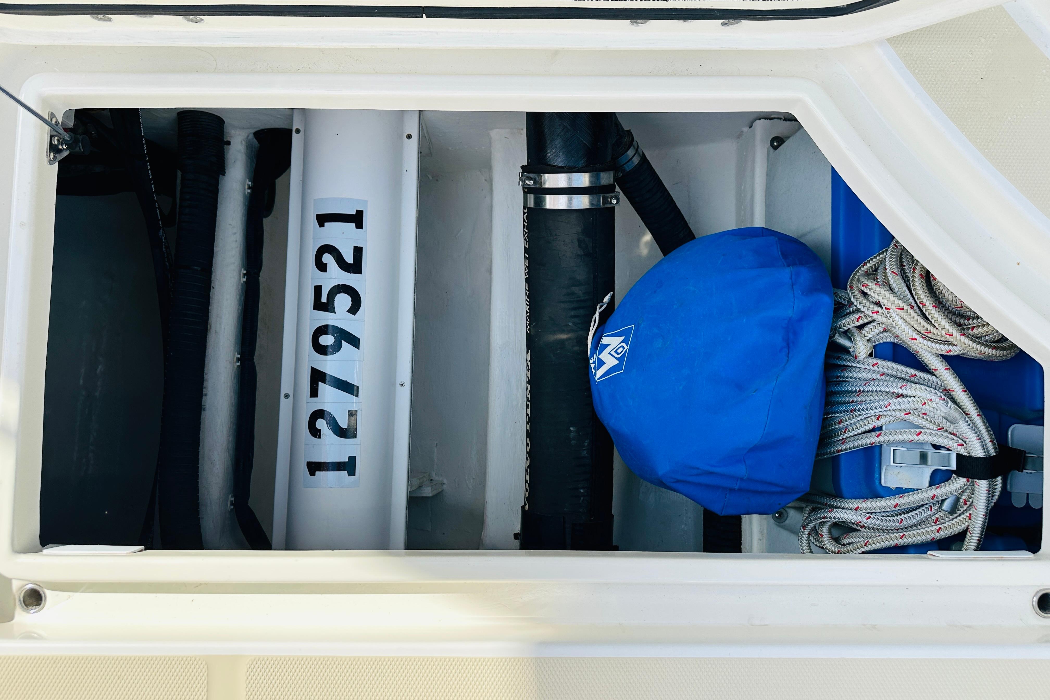 Storage compartment of 2017 Sabre 42 Salon Express with ropes and blue cover.