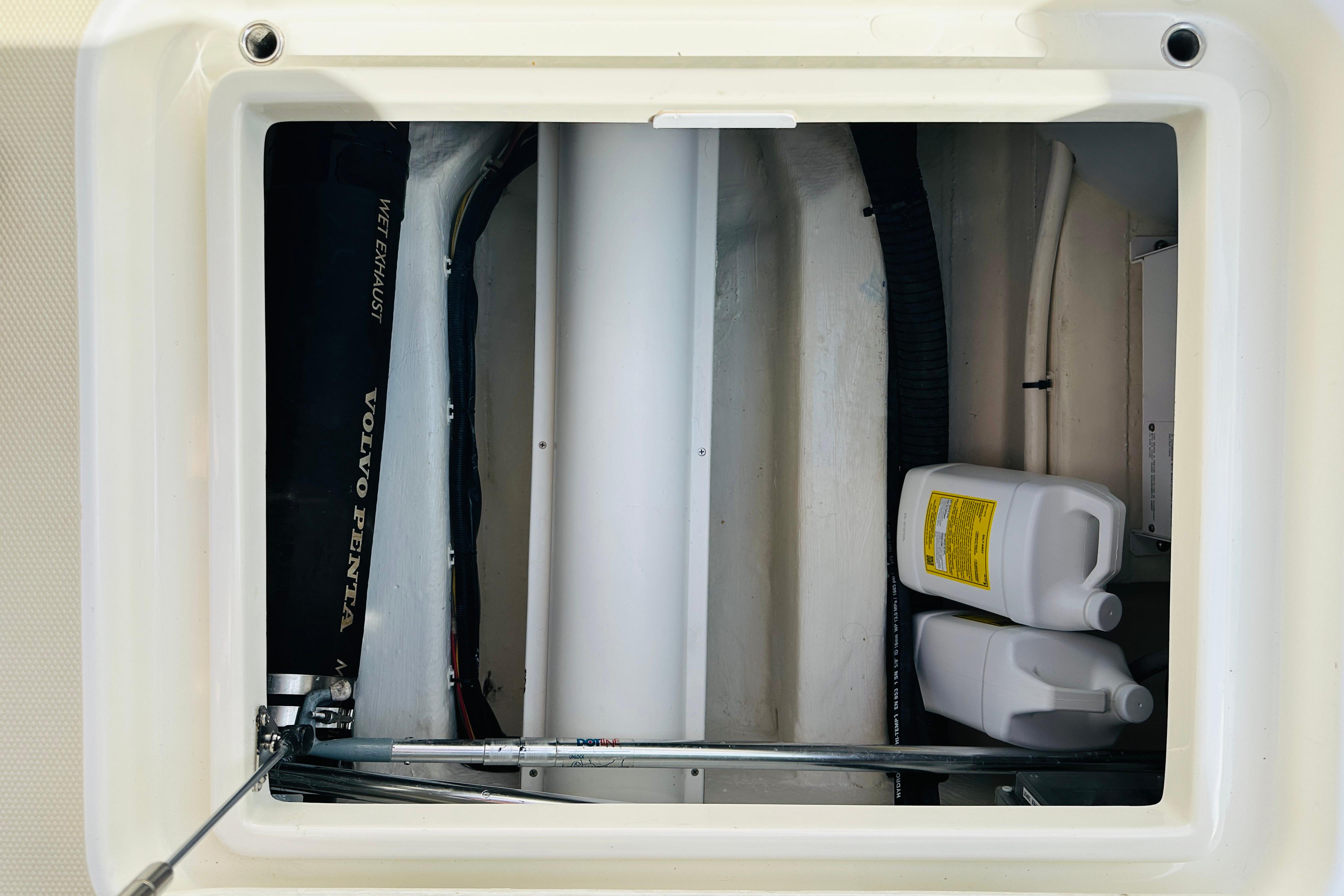Engine compartment of 2017 Sabre 42 Salon Express with Volvo Penta components and fluid containers.