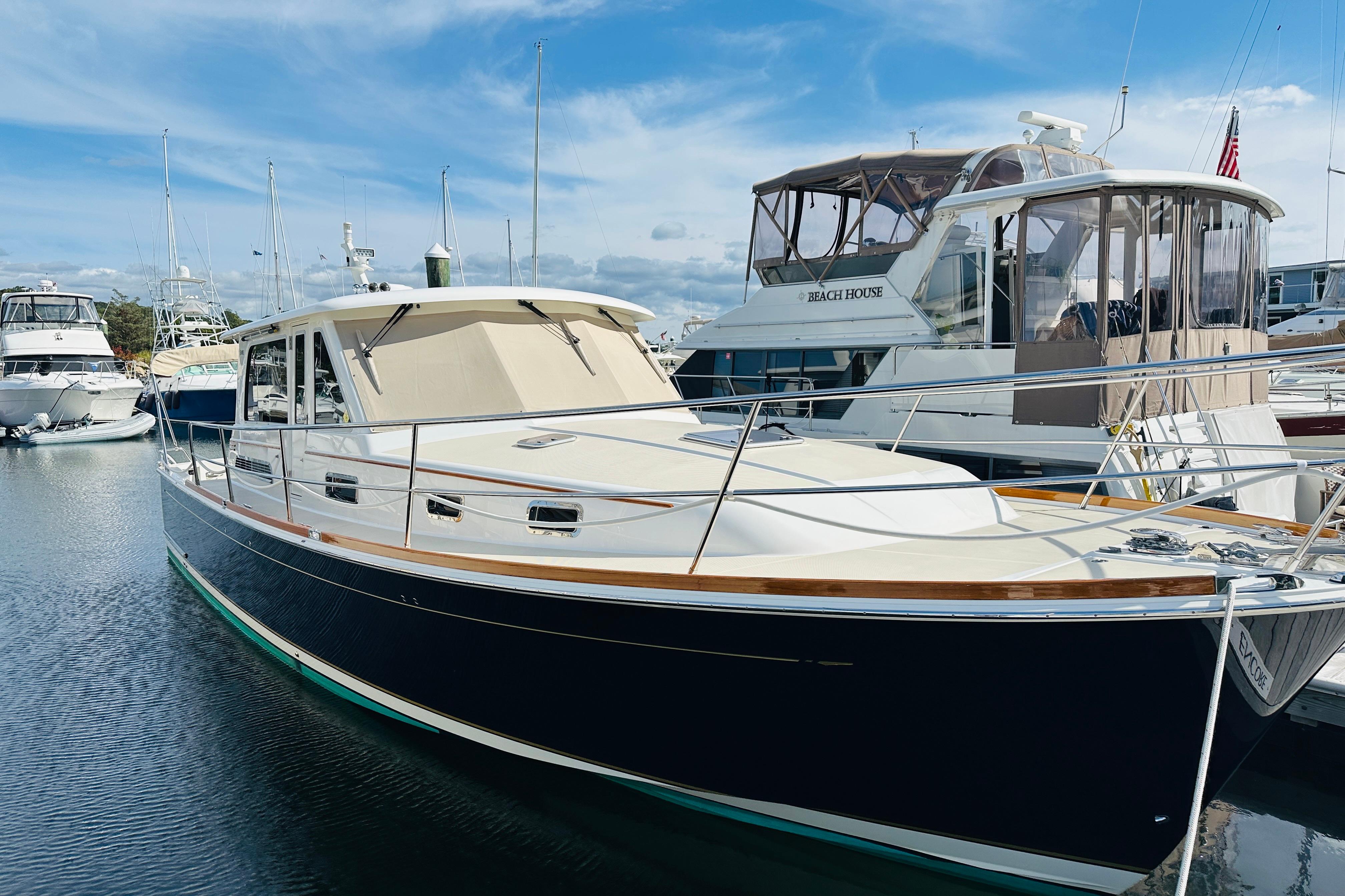 2017 Sabre 42 Salon Express yacht docked at marina under blue sky.