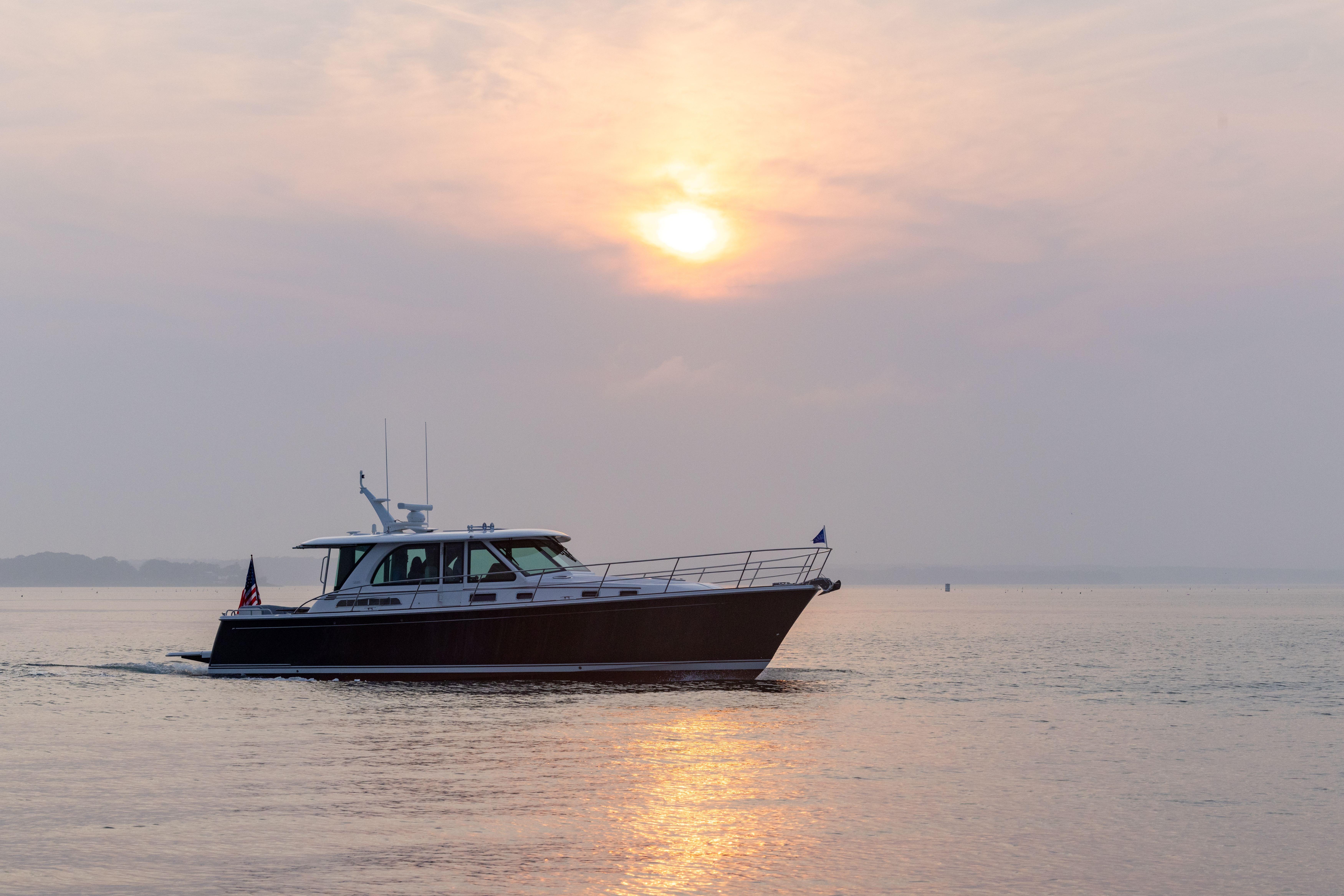 2026 Sabre 45 Salon Express yacht cruising at sunset on calm waters.