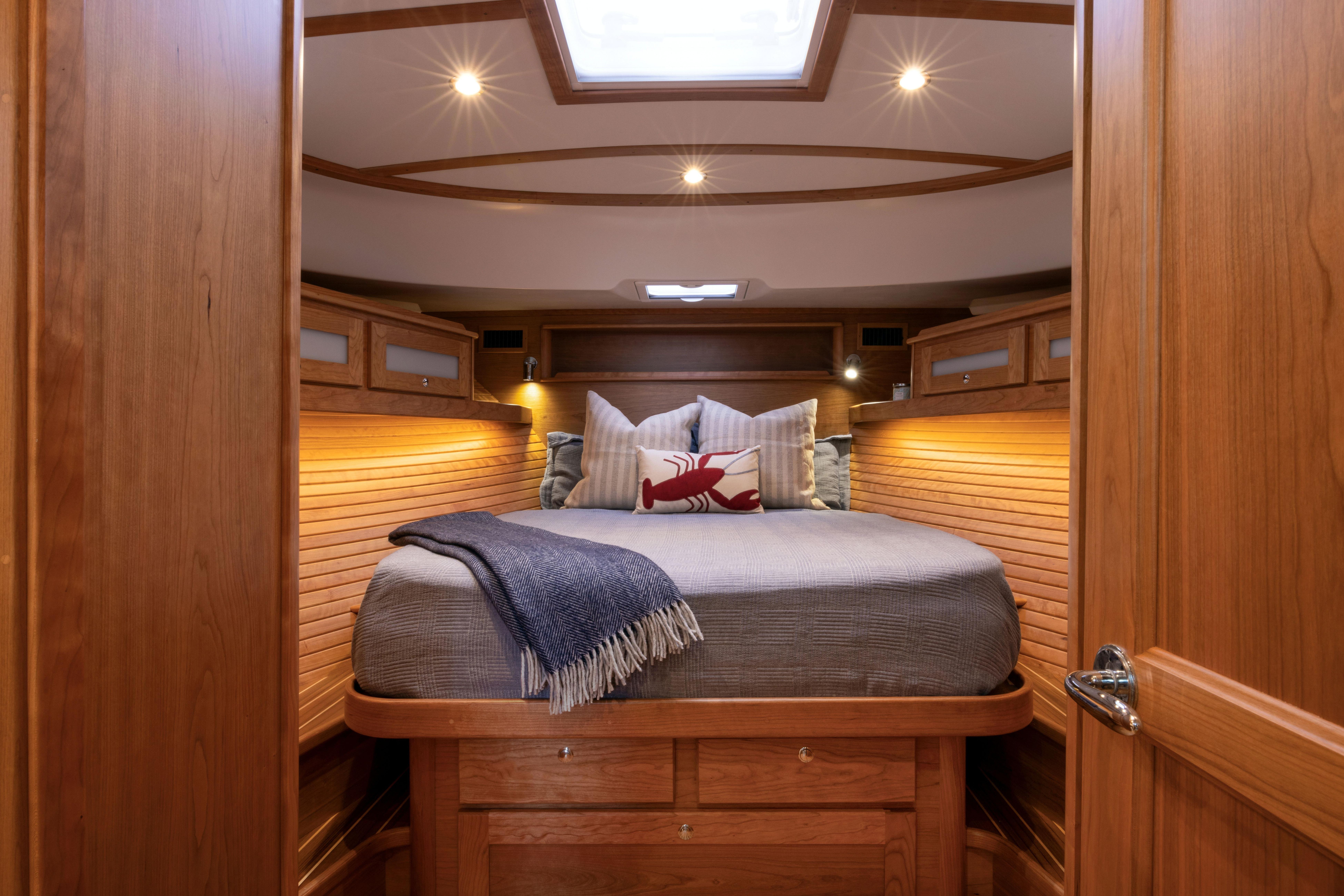 Luxurious cabin interior of 2026 Sabre 45 Salon Express yacht with cozy bedding.