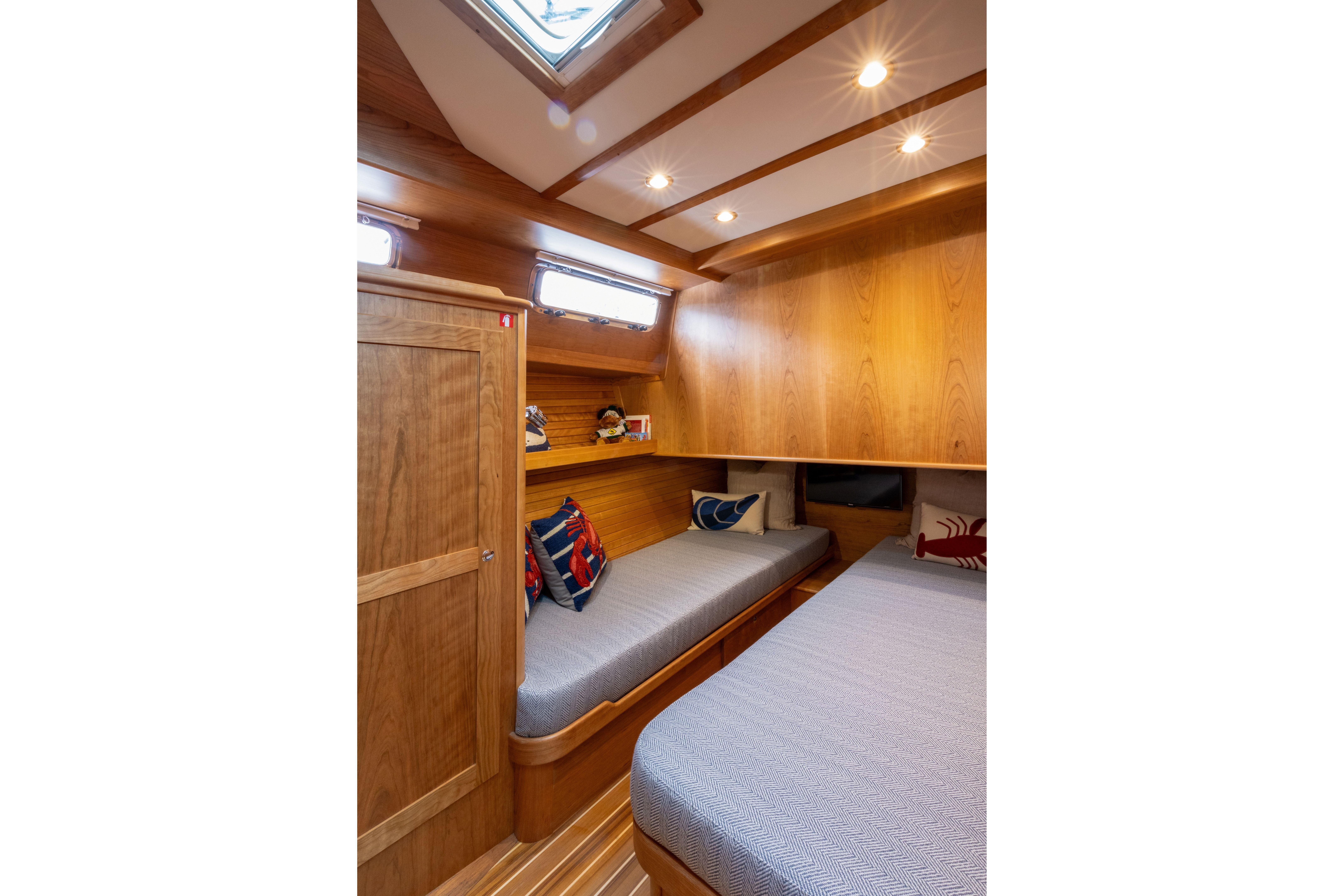 2026 Sabre 45 Salon Express cabin with wooden interior and cozy twin beds.