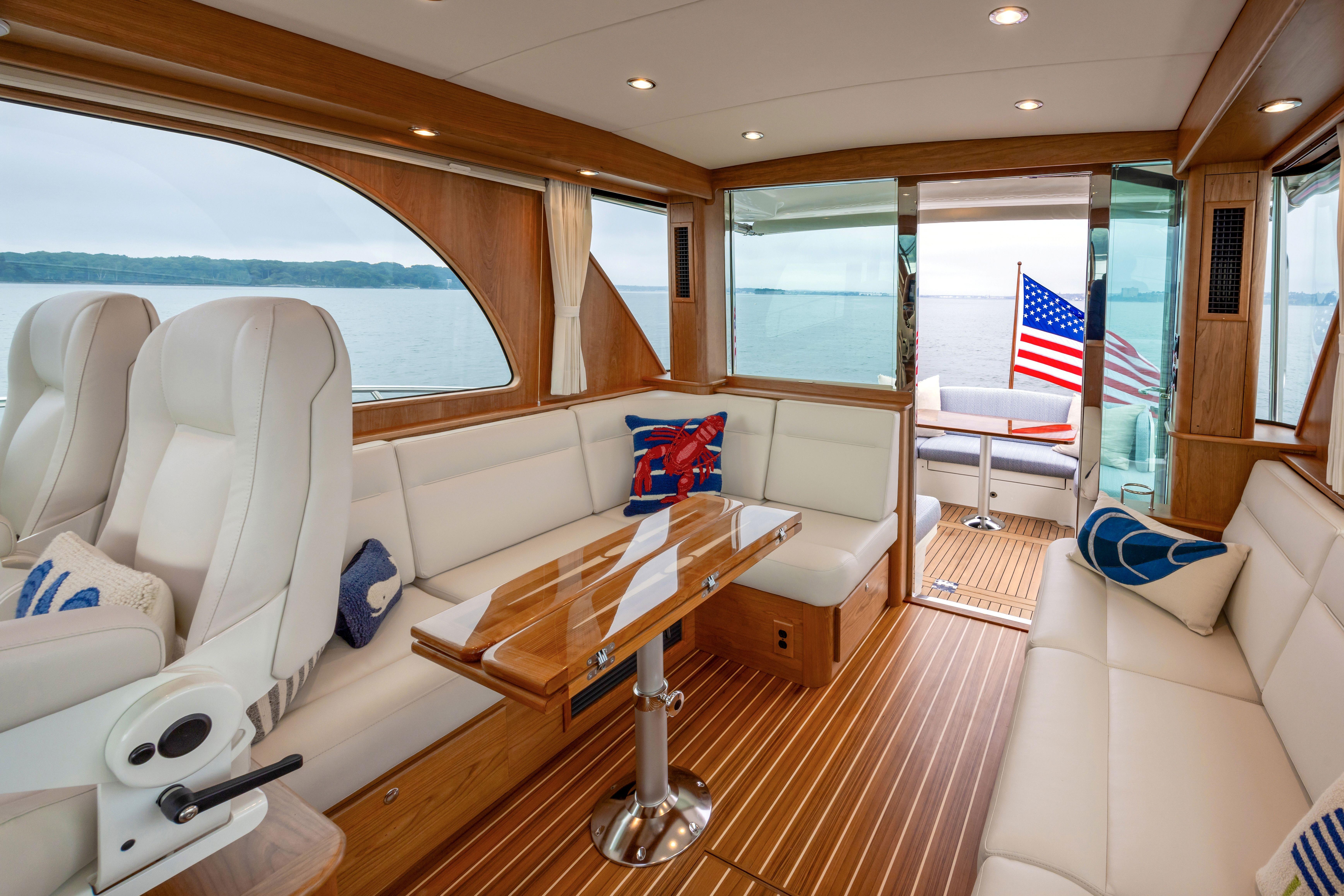 Luxurious interior of 2026 Sabre 45 Salon Express yacht with elegant seating and wooden finishes.