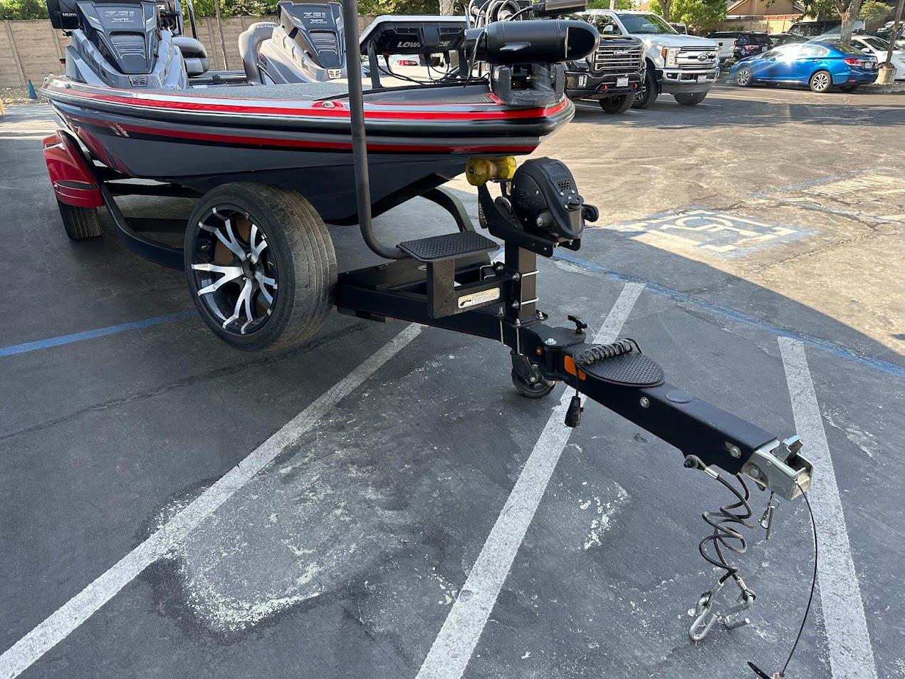2023 Nitro Z21 XL Pro boat on trailer in parking lot.