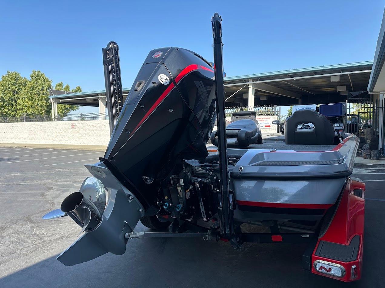 2023 Nitro Z21 XL Pro boat with powerful outboard motor in a parking area.