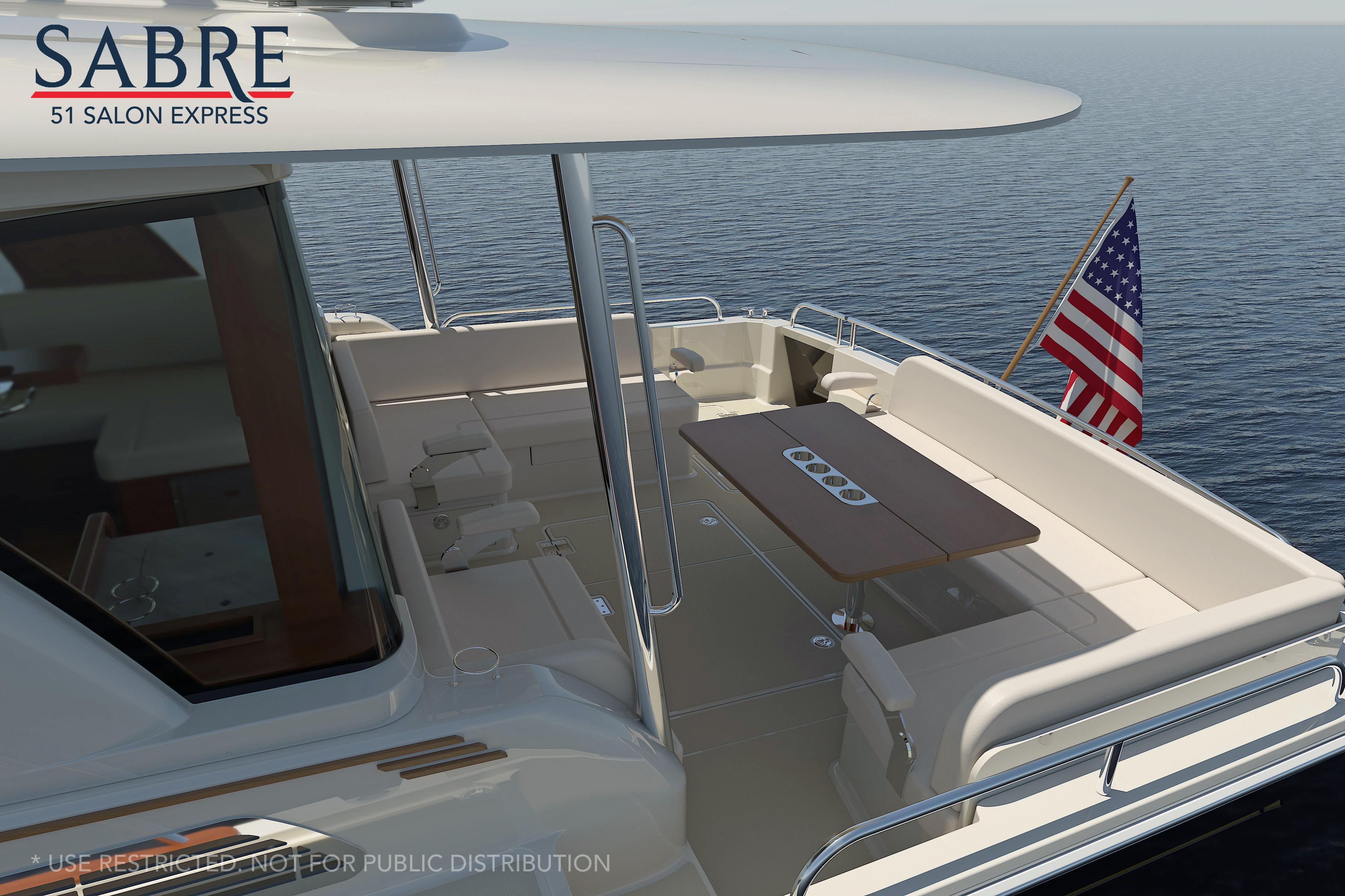 Luxurious 2026 Sabre 51 yacht deck with seating and American flag on open sea.