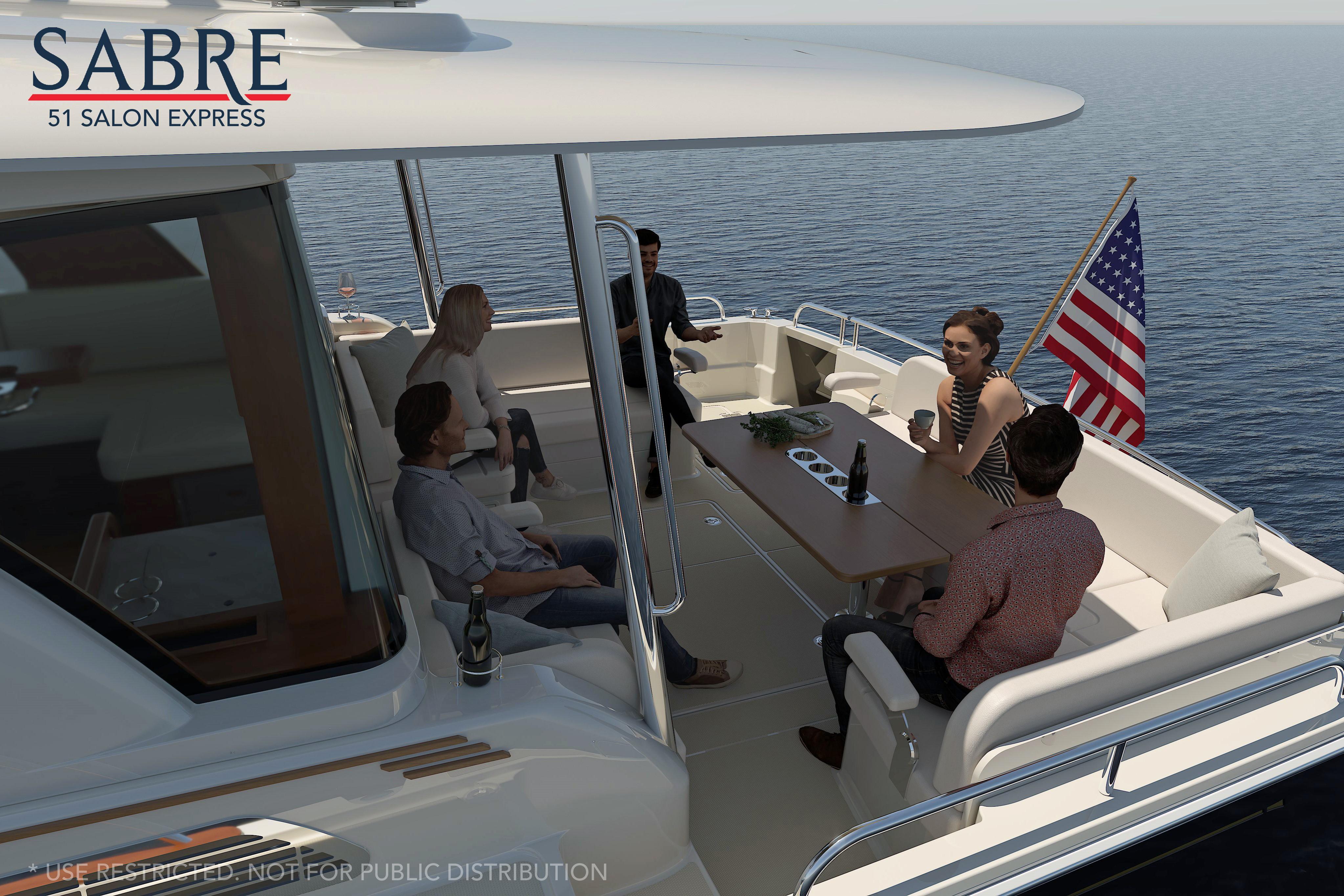 People relaxing on a Sabre 51 yacht, 2026 model, enjoying a sunny day at sea.