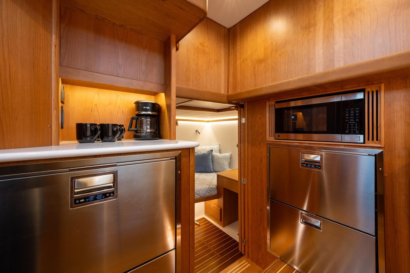 Luxurious interior of 2027 Sabre 51 Salon Express yacht with modern kitchen amenities.