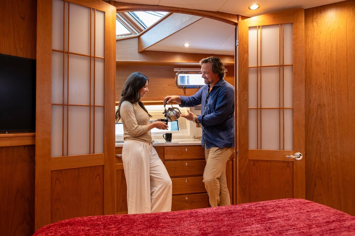 Couple enjoying coffee in the cozy interior of a 2027 Sabre 51 Salon Express yacht.