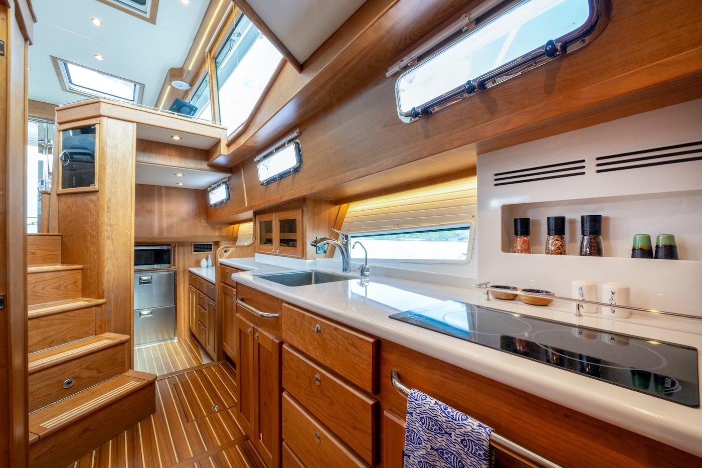 Luxurious interior of 2027 Sabre 51 Salon Express yacht with modern kitchen amenities.