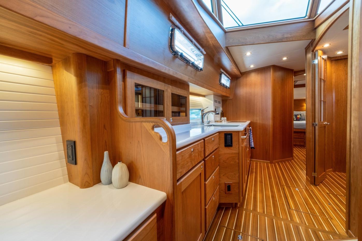 Luxurious interior of 2027 Sabre 51 Salon Express yacht with elegant wood finishes.
