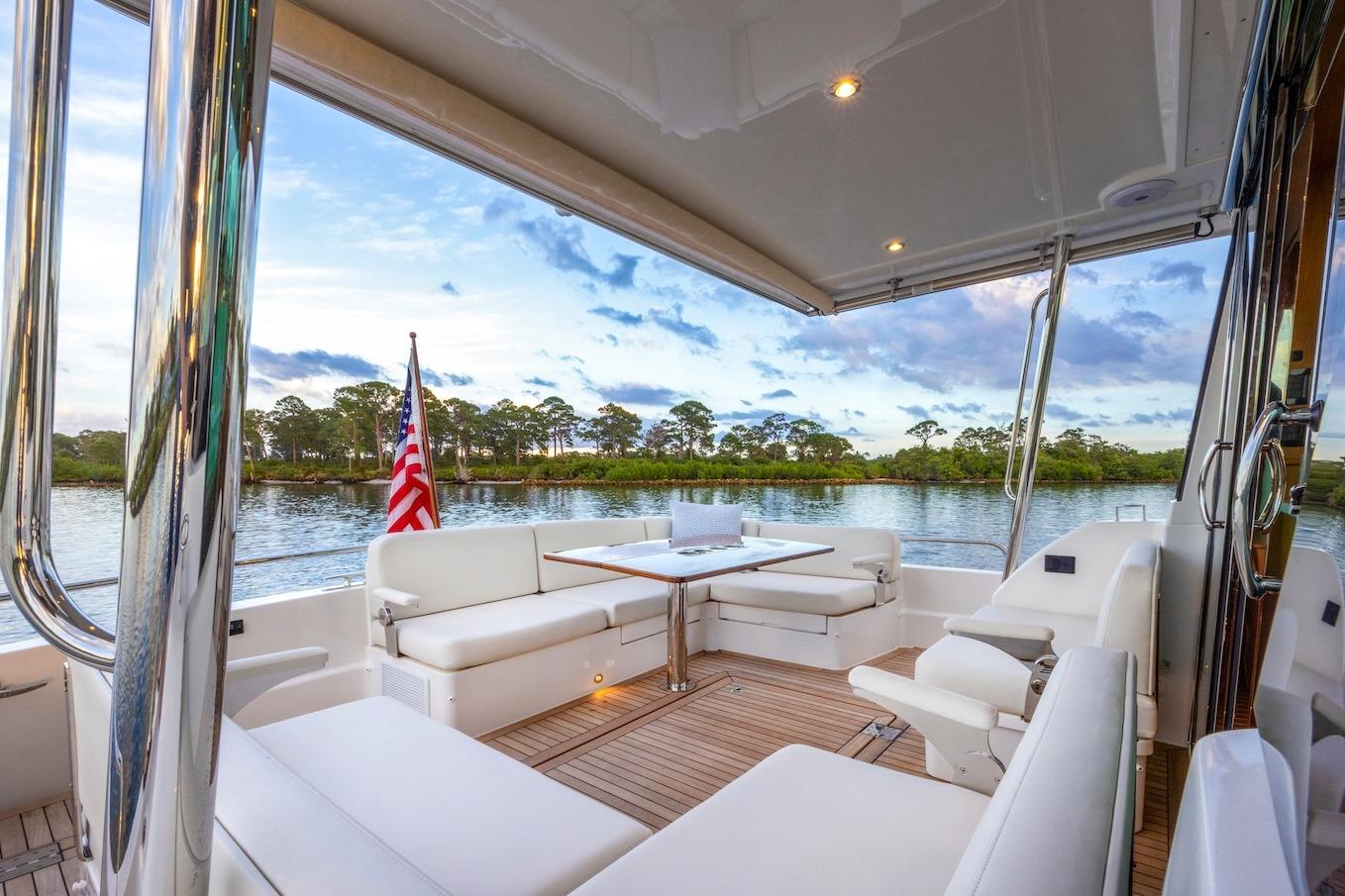 Luxurious 2027 Sabre 51 Salon Express yacht interior with elegant seating and scenic water view.