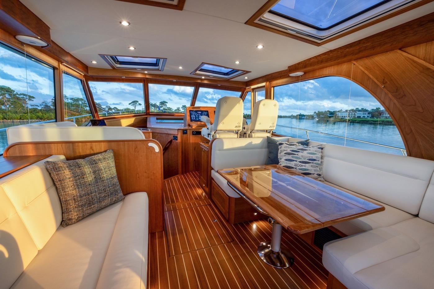Luxurious interior of 2027 Sabre 51 Salon Express yacht with elegant wood finishes.