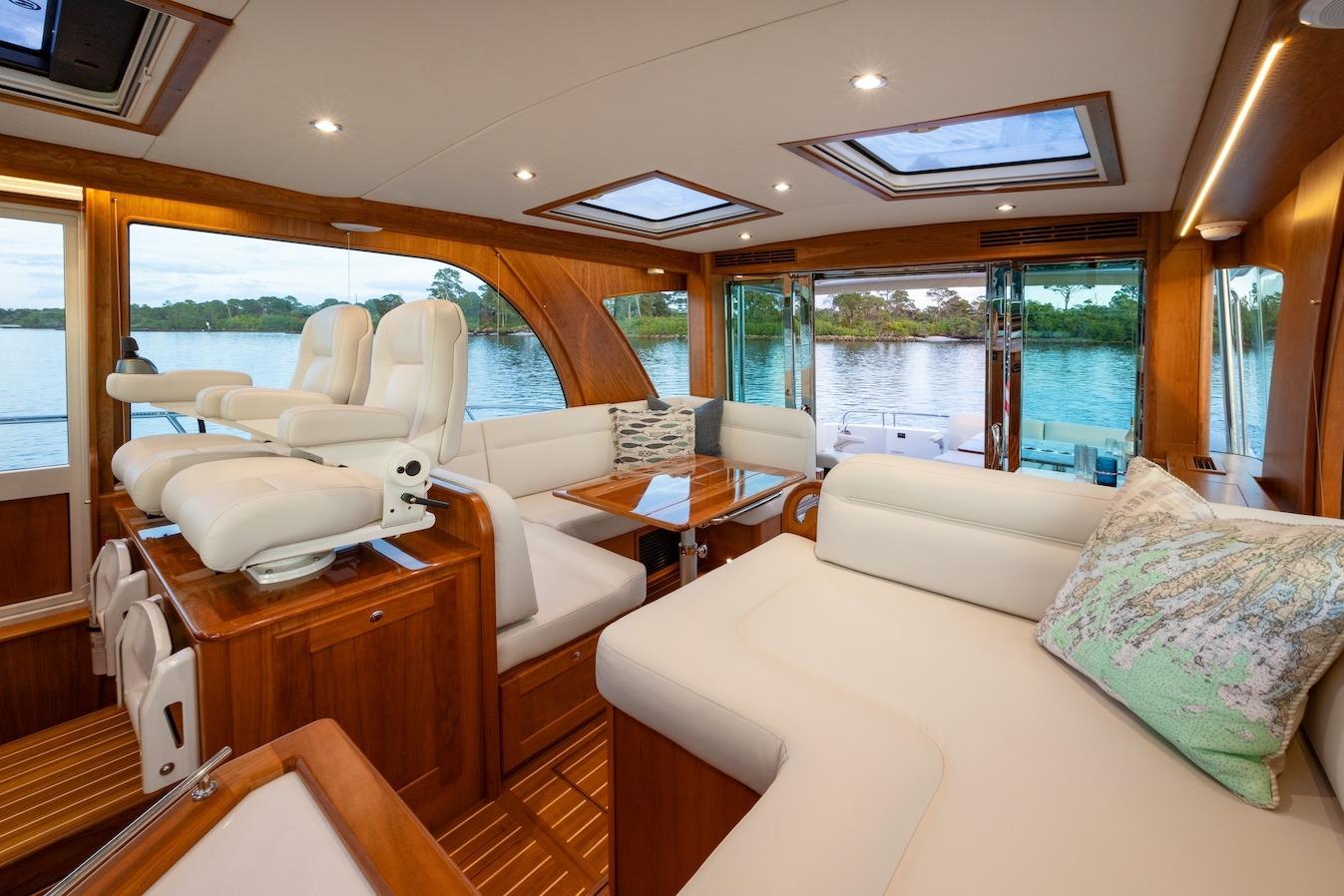 Luxurious interior of 2027 Sabre 51 Salon Express yacht with elegant seating and scenic views.