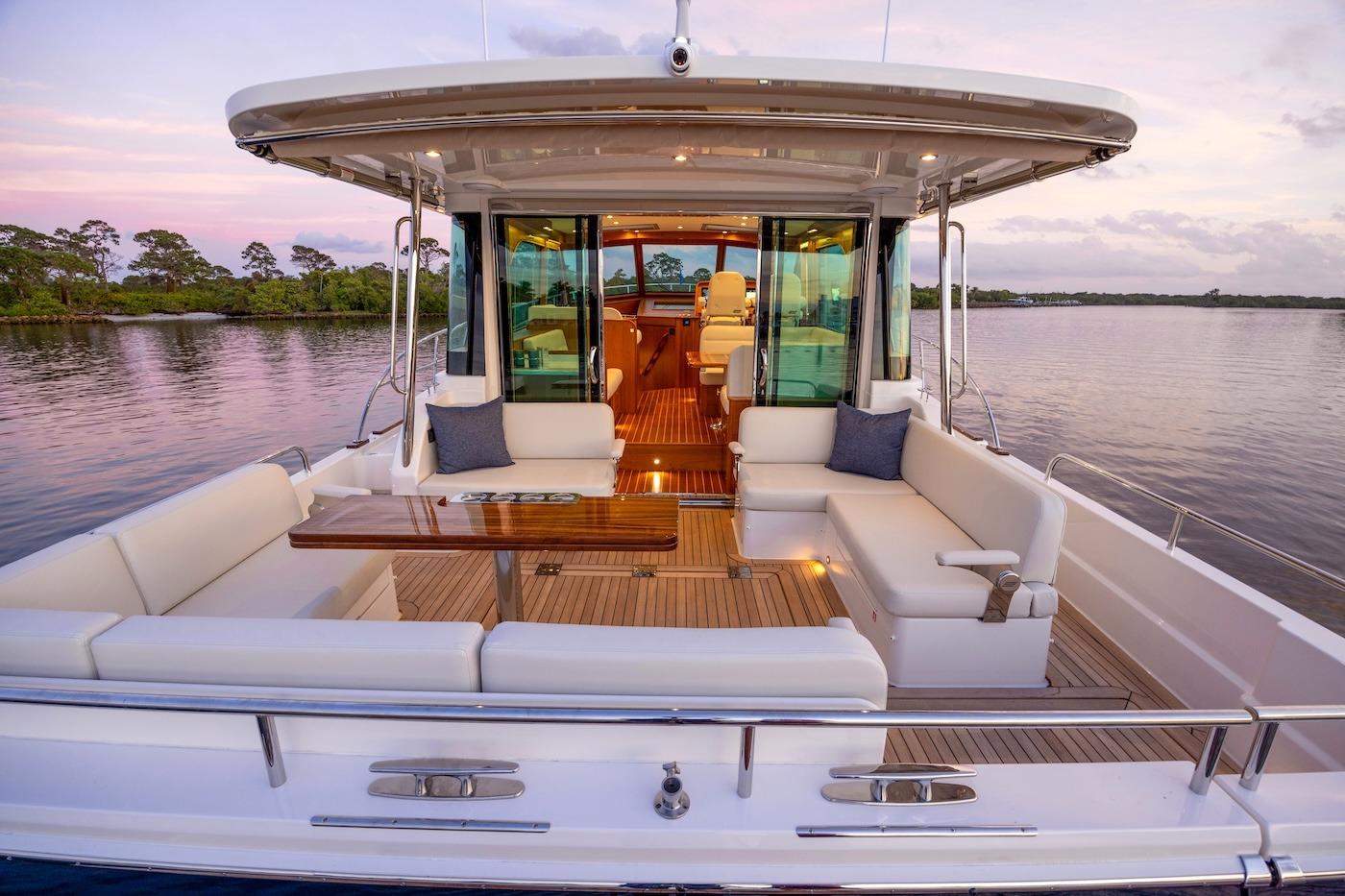 Luxurious 2027 Sabre 51 Salon Express yacht with elegant outdoor seating and scenic water view.
