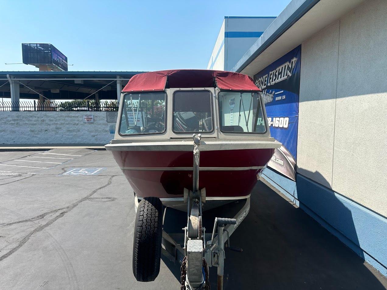 2003 Alumaweld Stryker boat on trailer, parked outside a building.