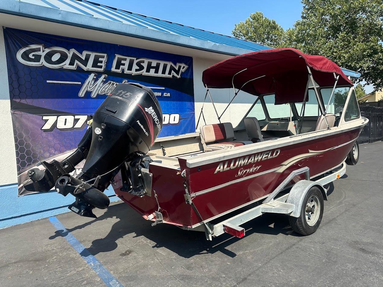 2003 Alumaweld Stryker boat with Mercury outboard motor, parked at Gone Fishin' Marine.