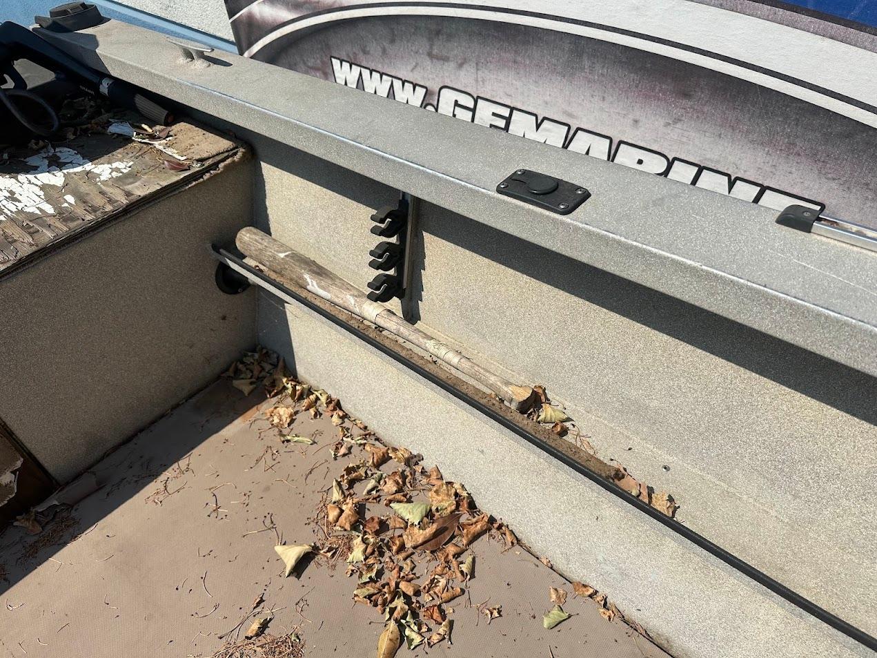 2003 Alumaweld Stryker boat interior with leaves and fishing rod holder.