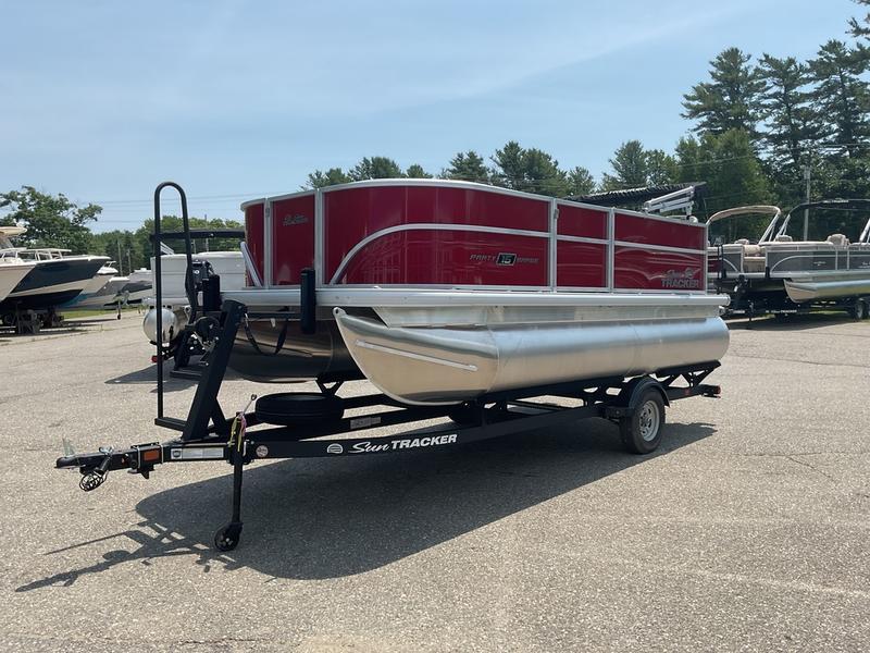 2026 Sun Tracker PB 16 DLX pontoon boat on trailer in outdoor lot.