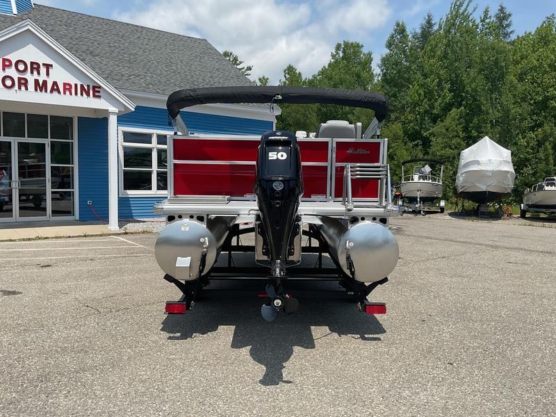 2026 Sun Tracker PB 16 DLX pontoon boat at marina, rear view.