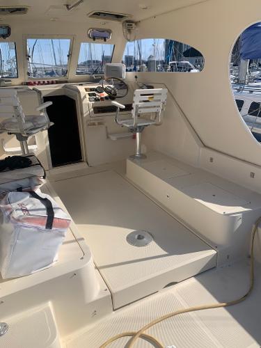 2004 Mainship Pilot 30-II Sedan interior with helm, seating, and nautical equipment.