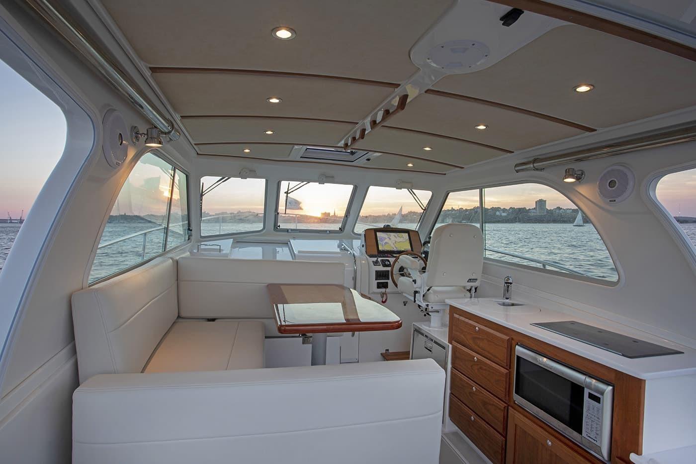 Luxurious interior of 2026 Back Cove 34O yacht with sunset view and modern amenities.