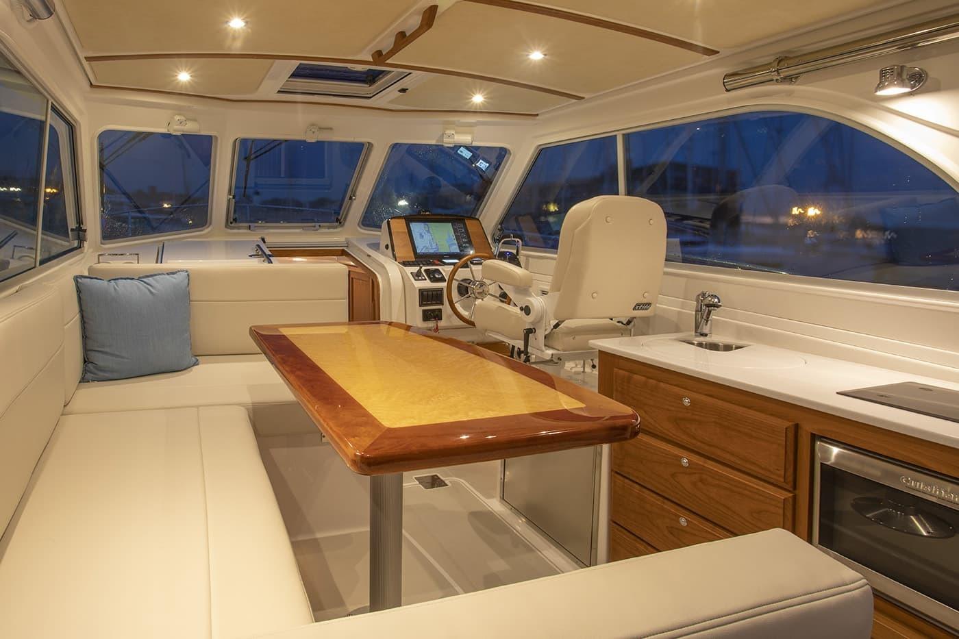 Luxurious interior of 2026 Back Cove 34O yacht with elegant seating and modern helm.