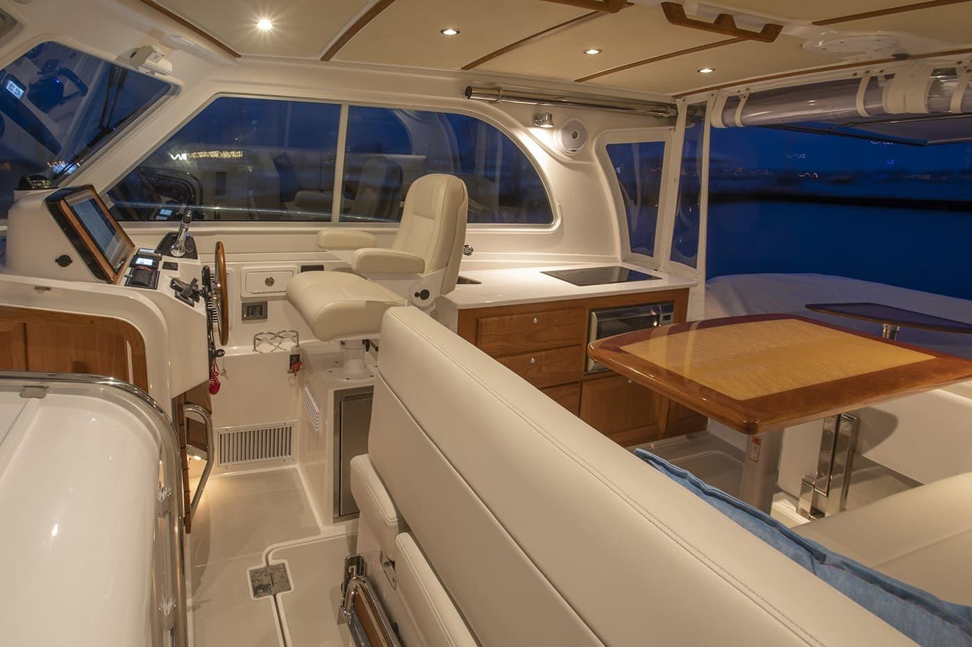 Luxurious interior of 2026 Back Cove 34O yacht with elegant seating and modern helm.