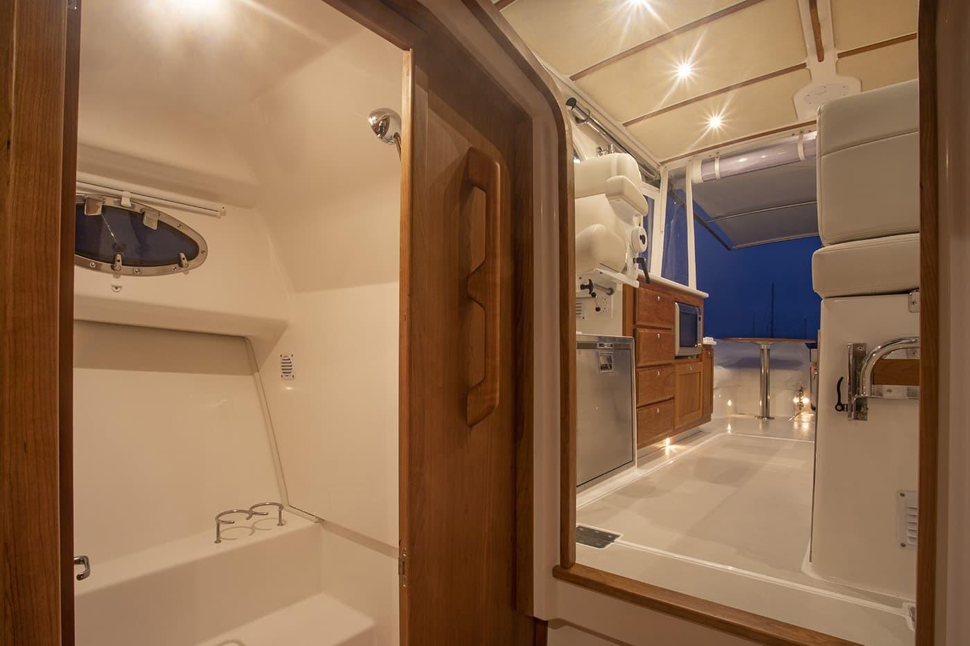 Interior view of 2026 Back Cove 34O yacht, featuring elegant wood finishes and modern amenities.