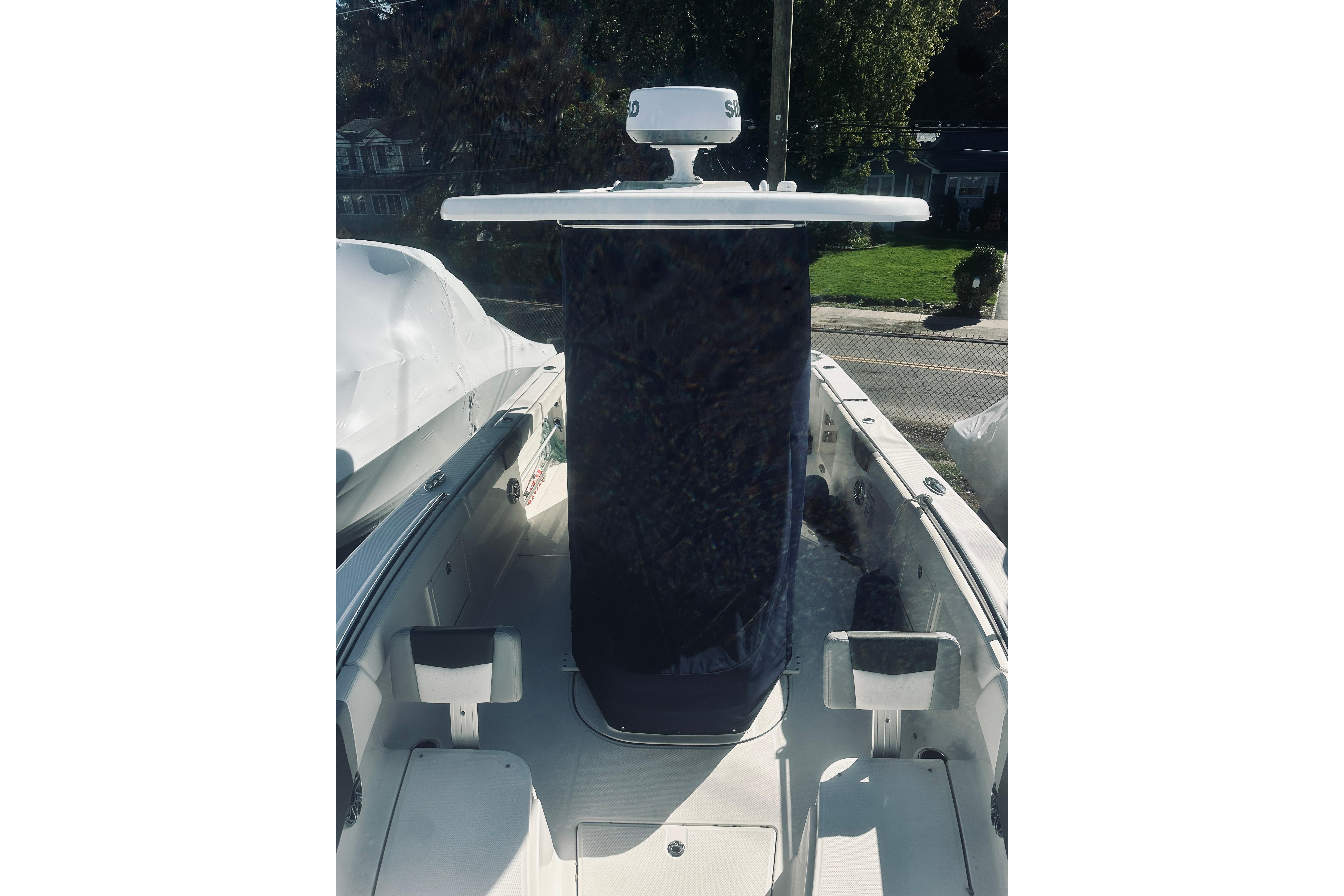 2022 Robalo R272 Center Console boat with radar, docked outdoors.