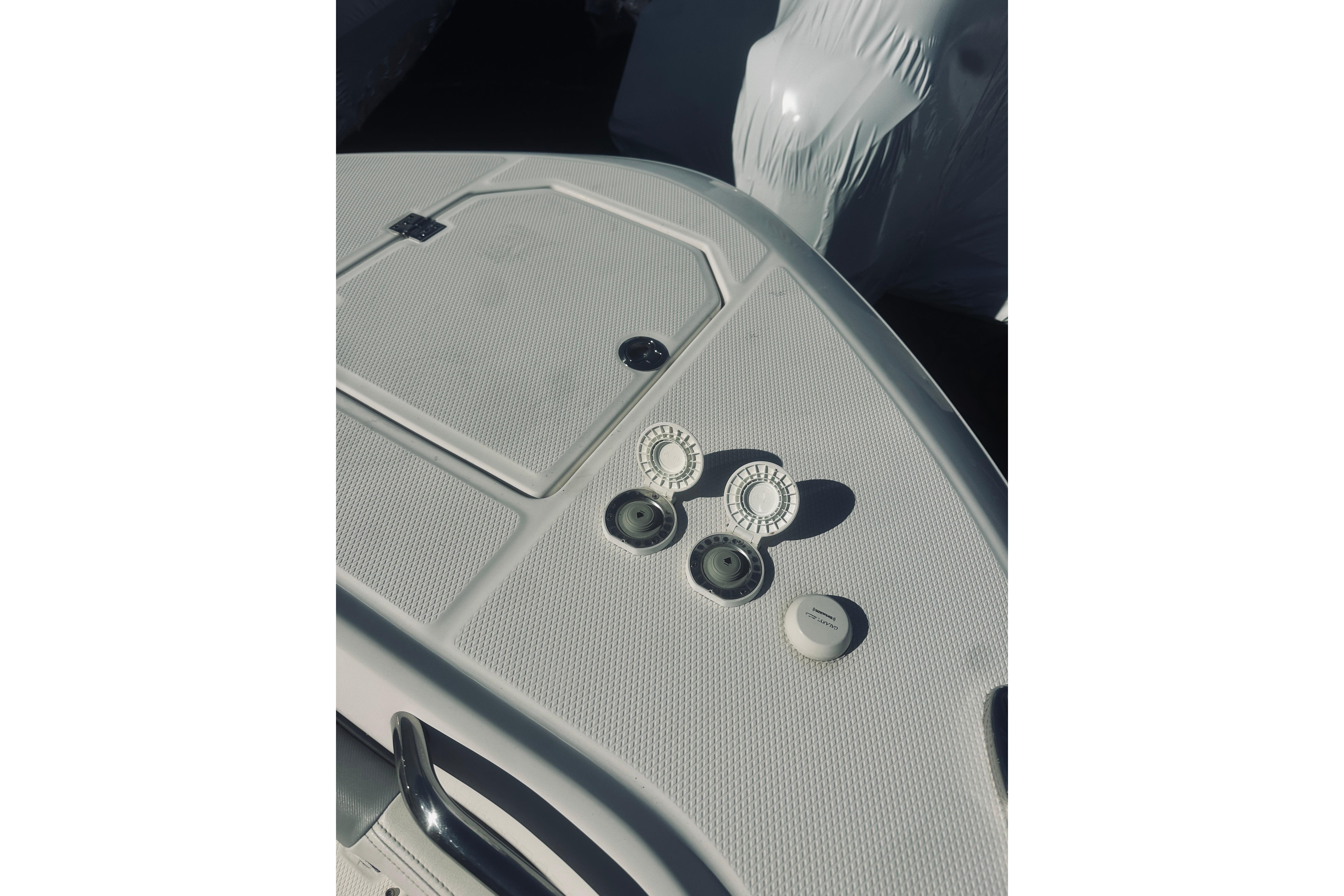 2022 Robalo R272 Center Console boat deck with fittings and textured surface.