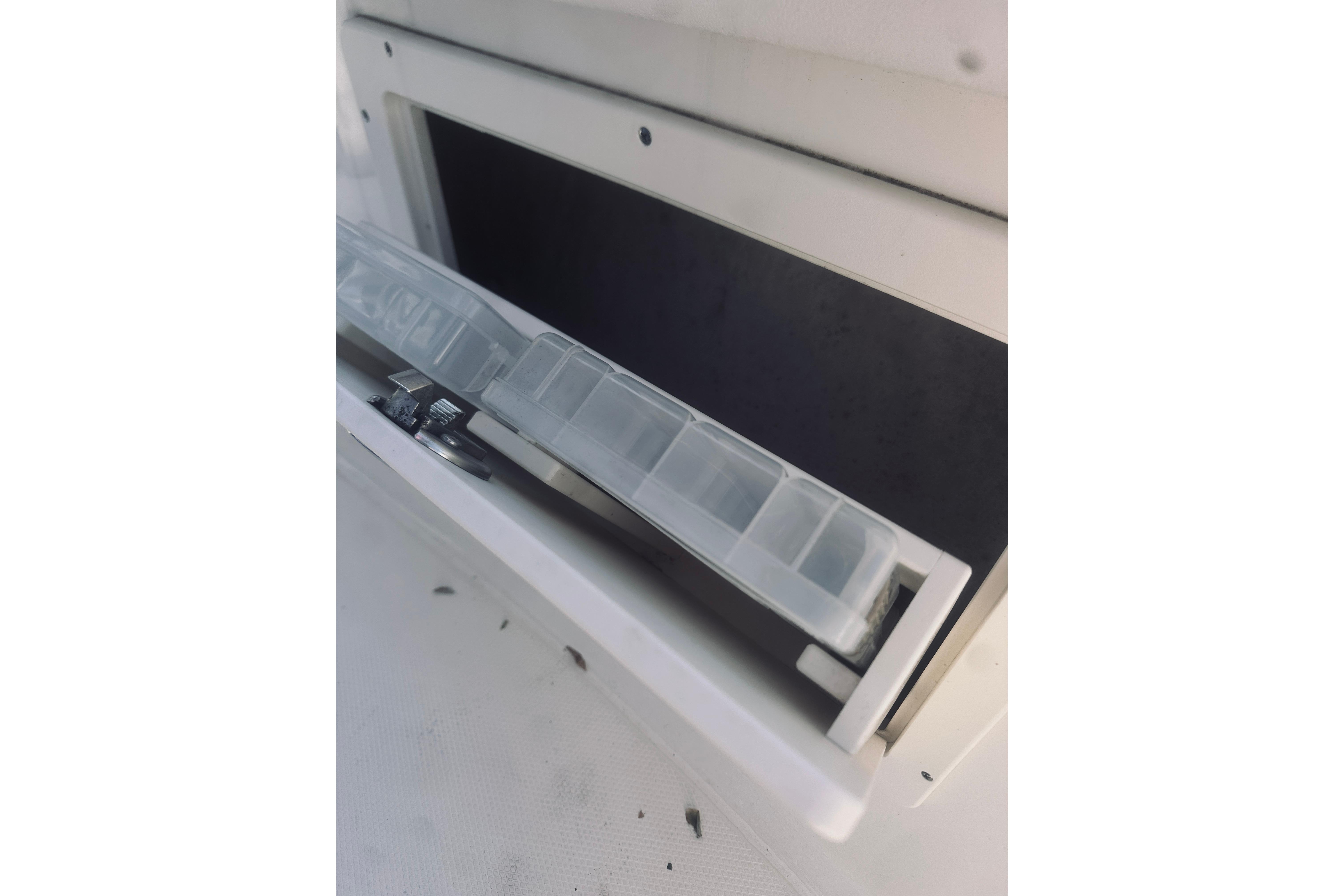 2022 Robalo R272 Center Console storage compartment with tackle box.