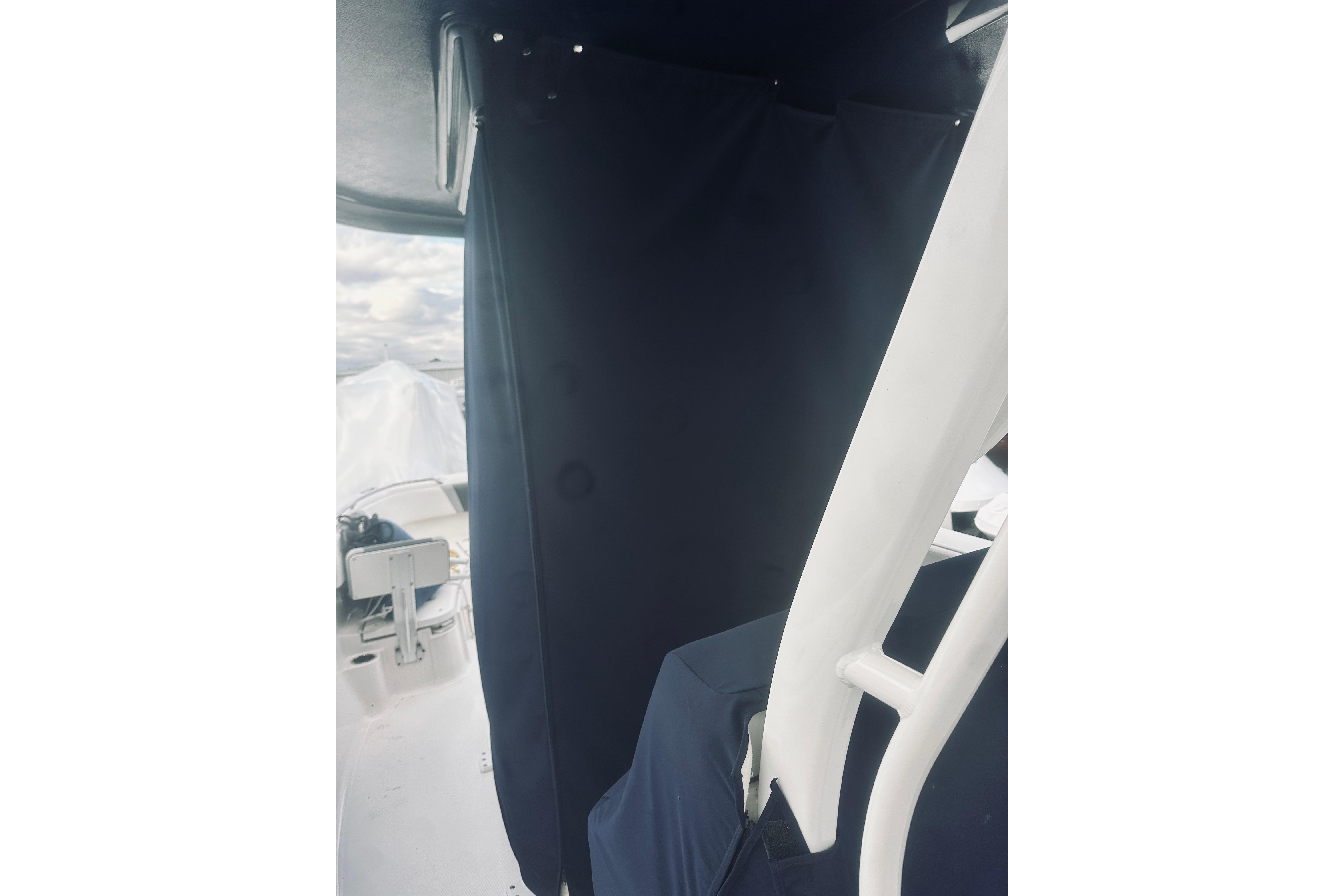 2022 Robalo R272 Center Console interior with dark curtain and white structural elements.