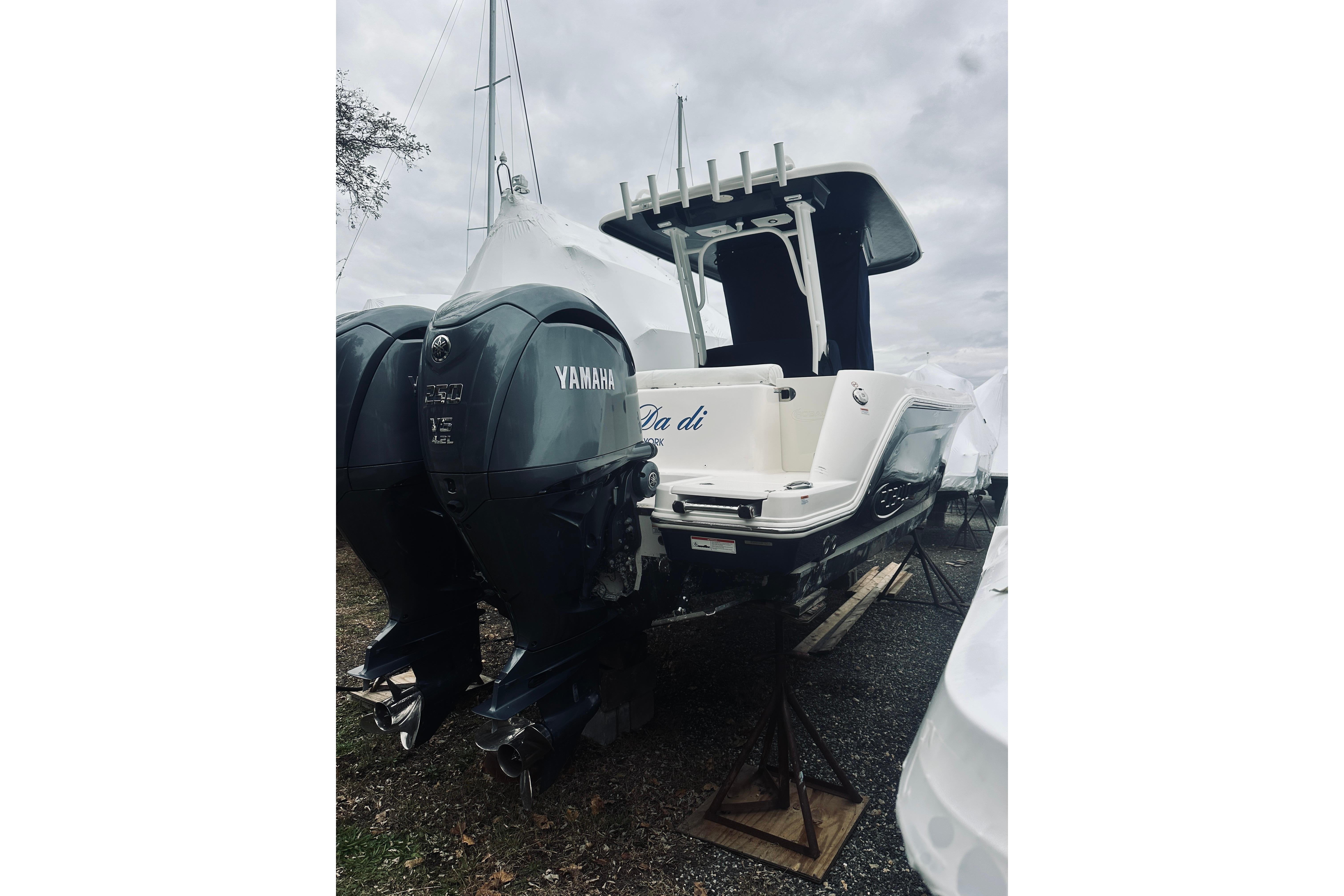 2022 Robalo R272 Center Console boat with Yamaha engines, parked on stands.