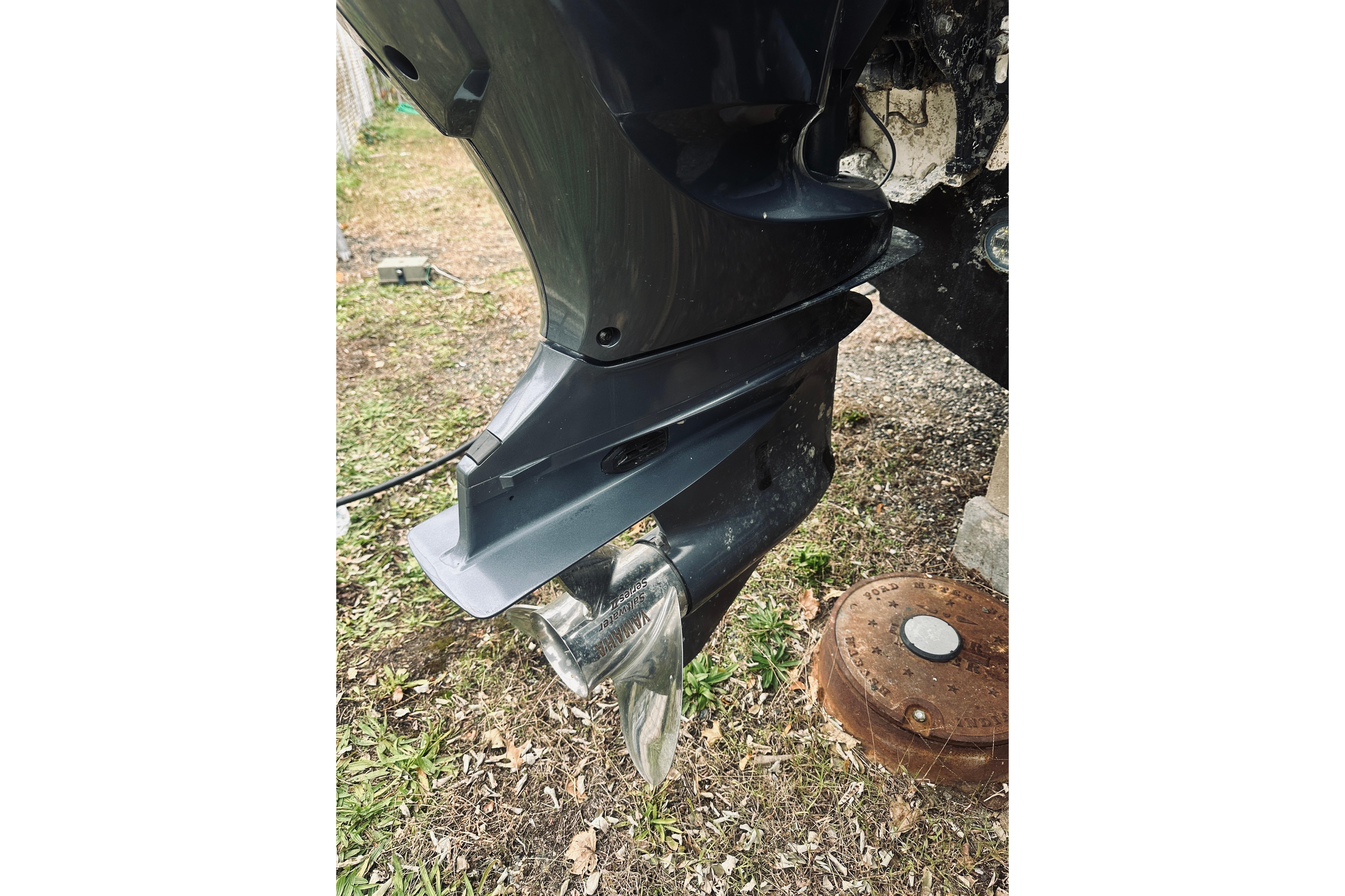 2022 Robalo R272 Center Console boat engine propeller on grass.