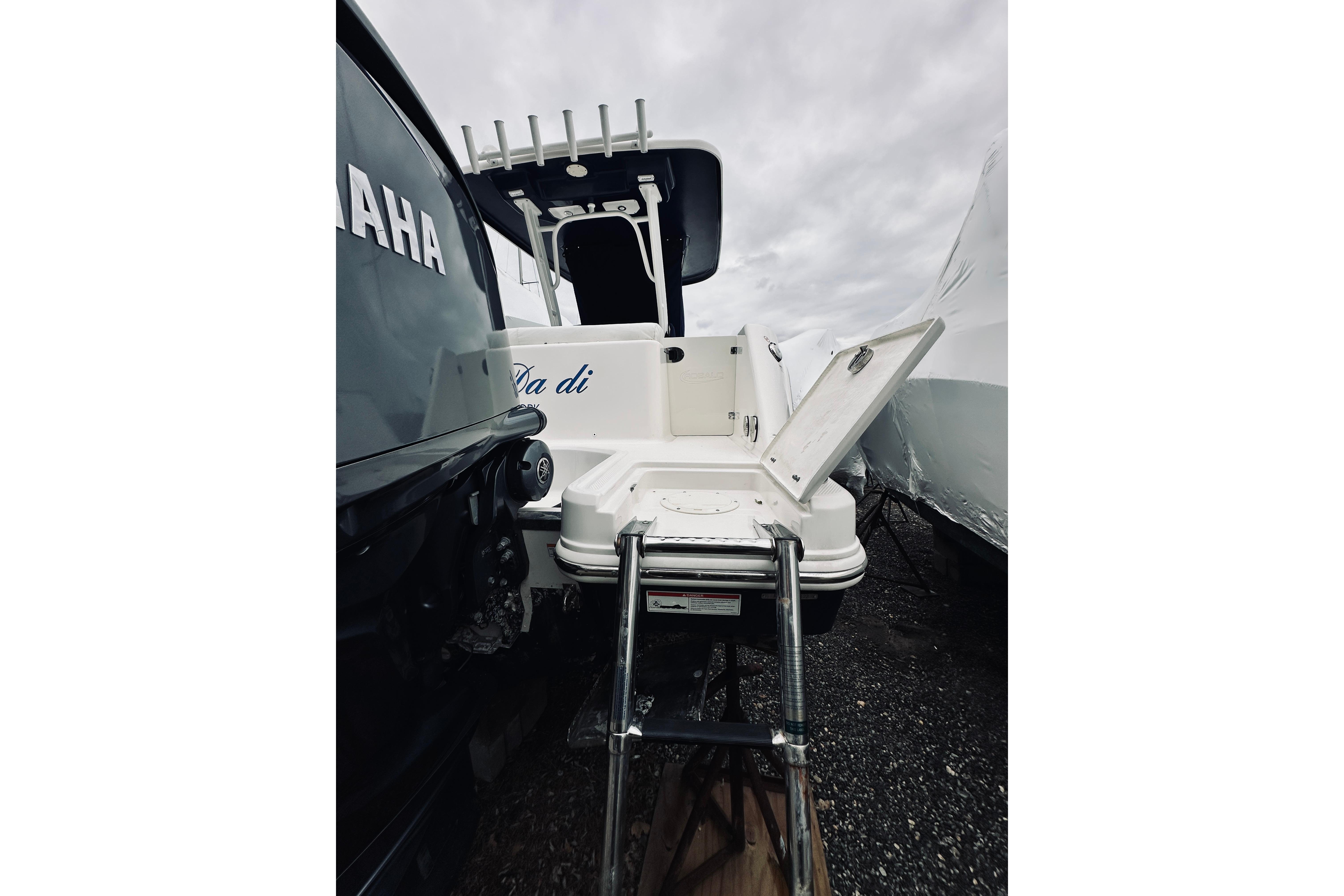 2022 Robalo R272 Center Console boat with Yamaha engine, rear view, ladder extended.