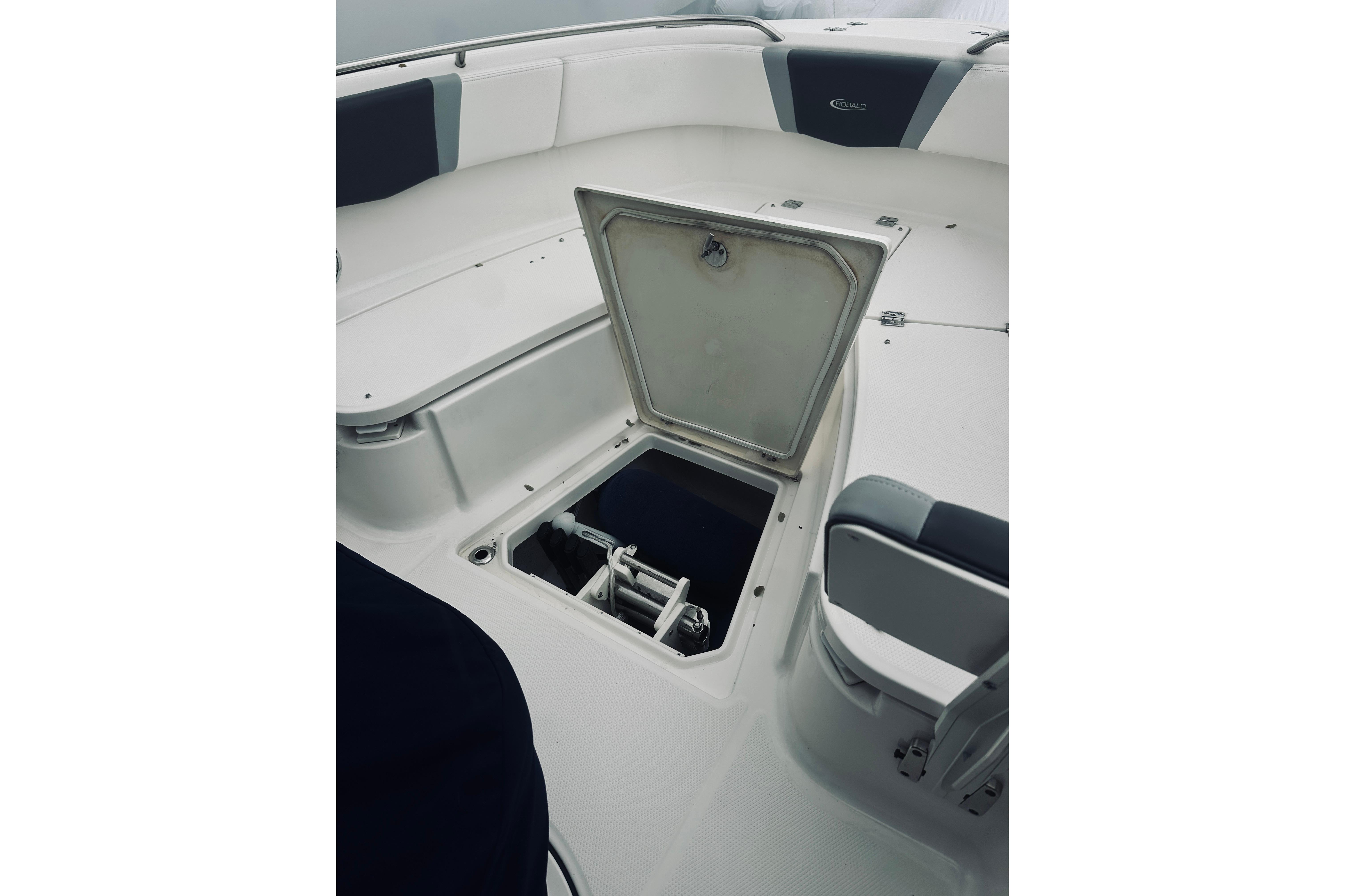 2022 Robalo R272 Center Console boat with open storage compartment.