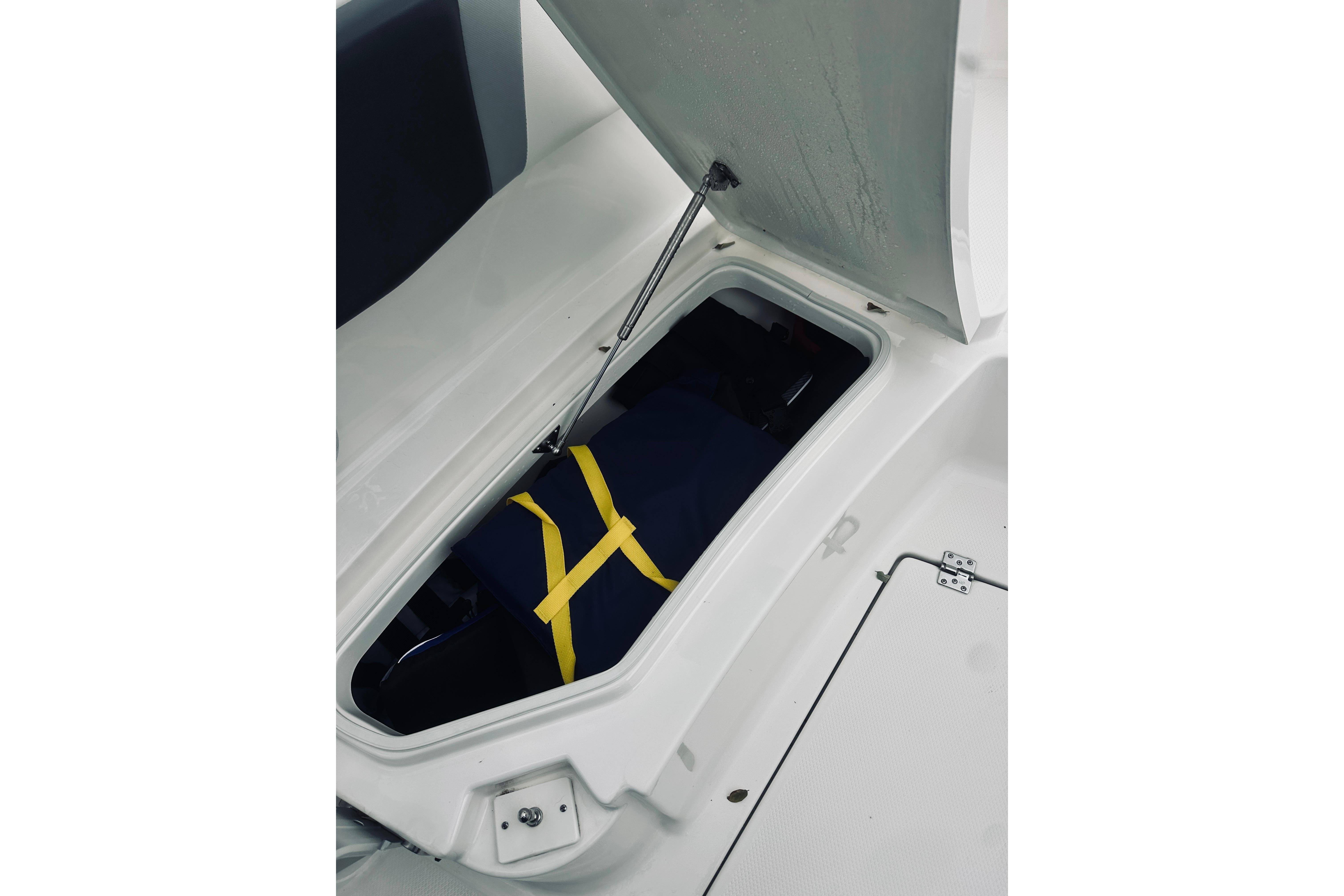 Storage compartment in 2022 Robalo R272 Center Console boat, featuring secure interior space.