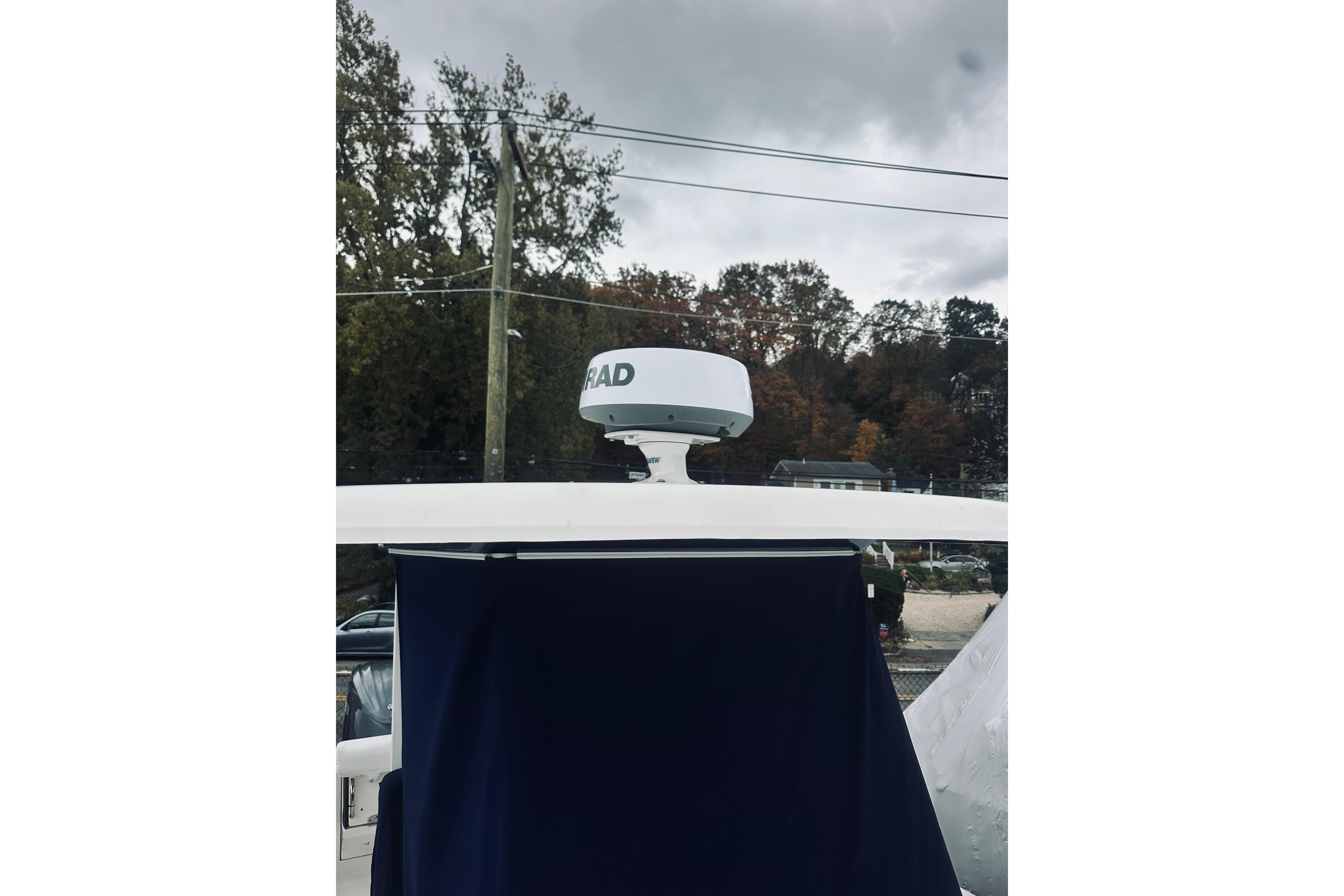 2022 Robalo R272 Center Console boat with radar, under cloudy sky.