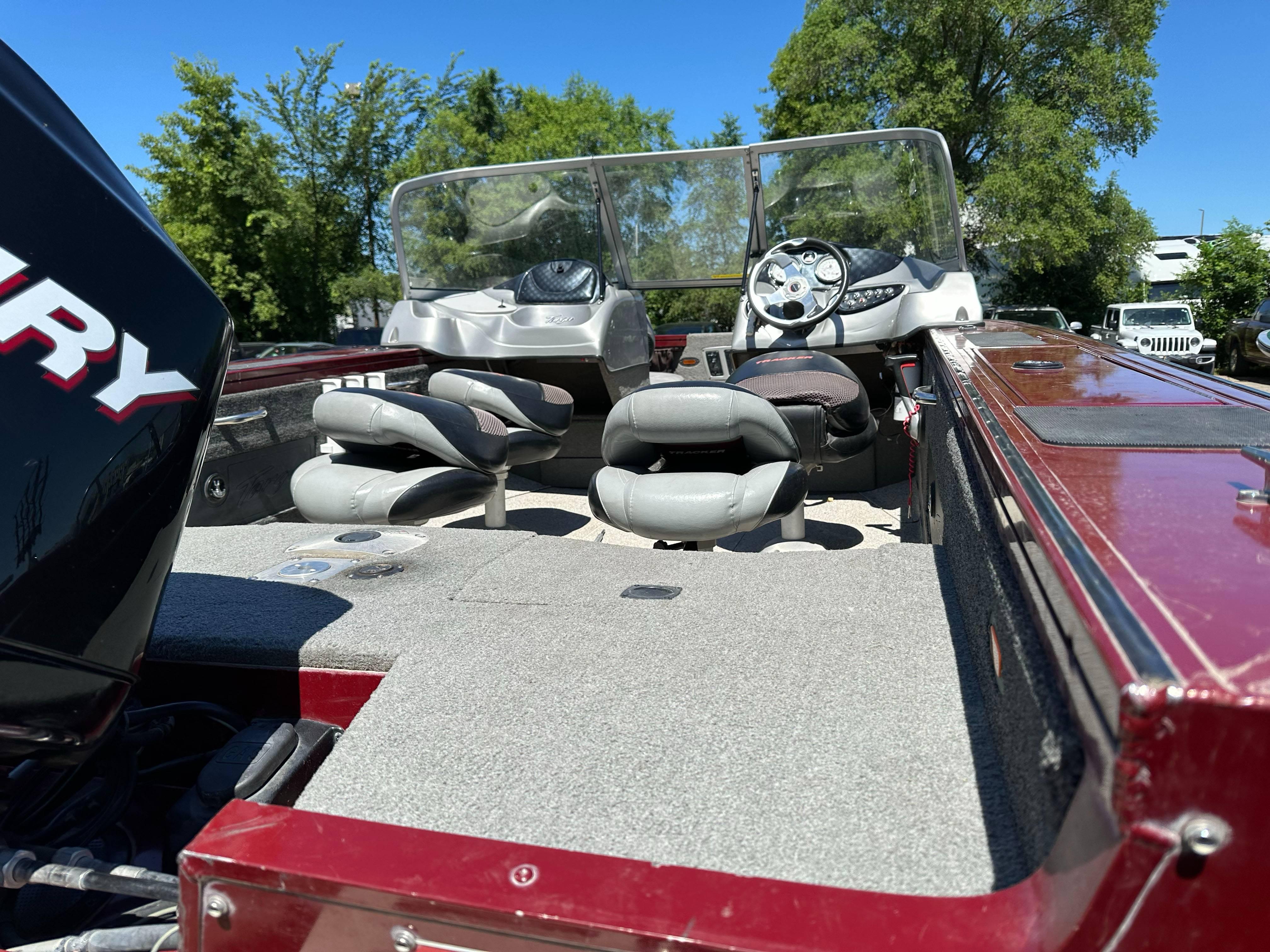2011 Tracker Targa V-18 Combo boat interior with seats and steering wheel, under clear blue sky.