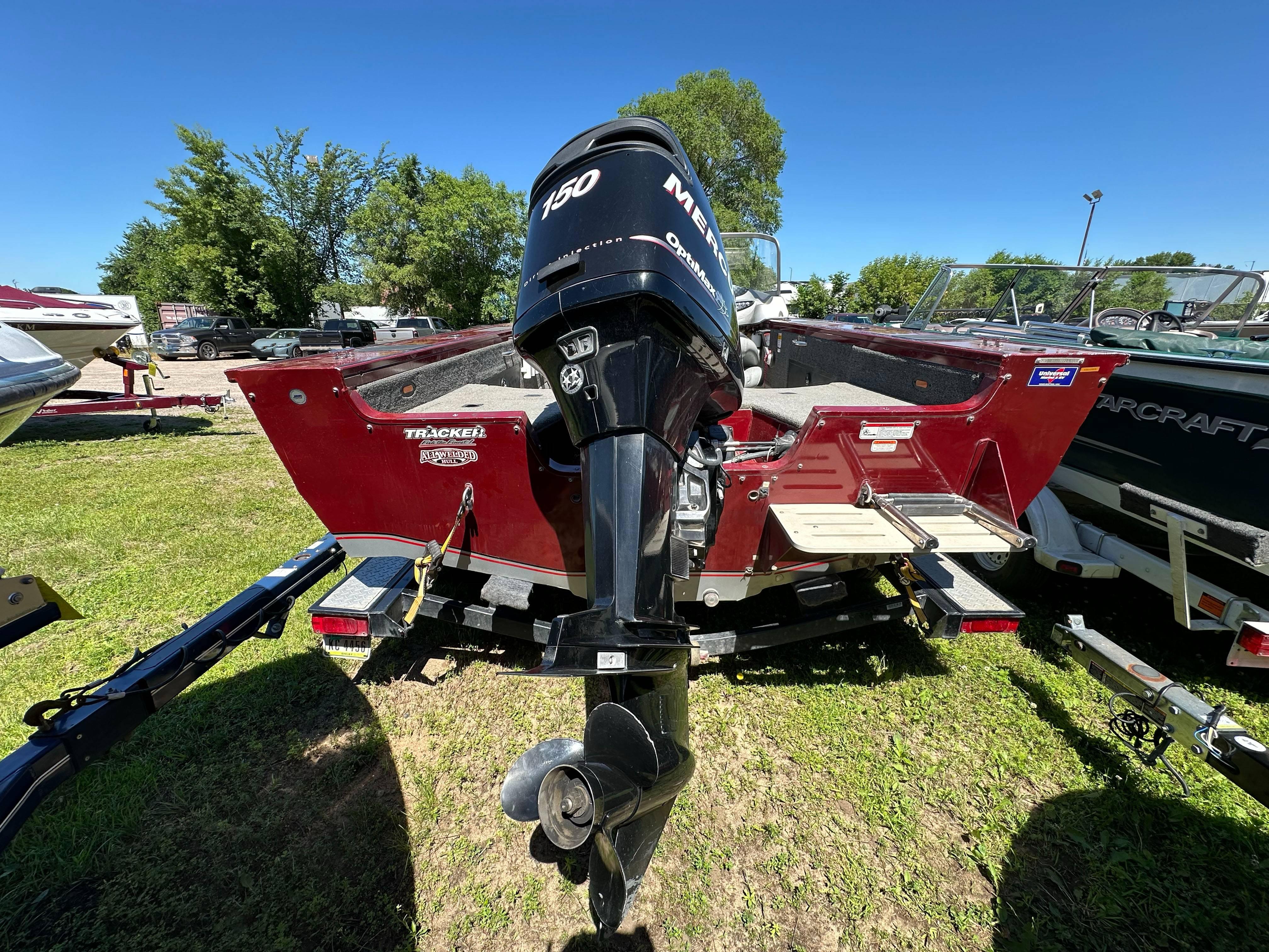 2011 Tracker Targa V-18 Combo boat with Mercury 150 outboard motor on grassy lot.