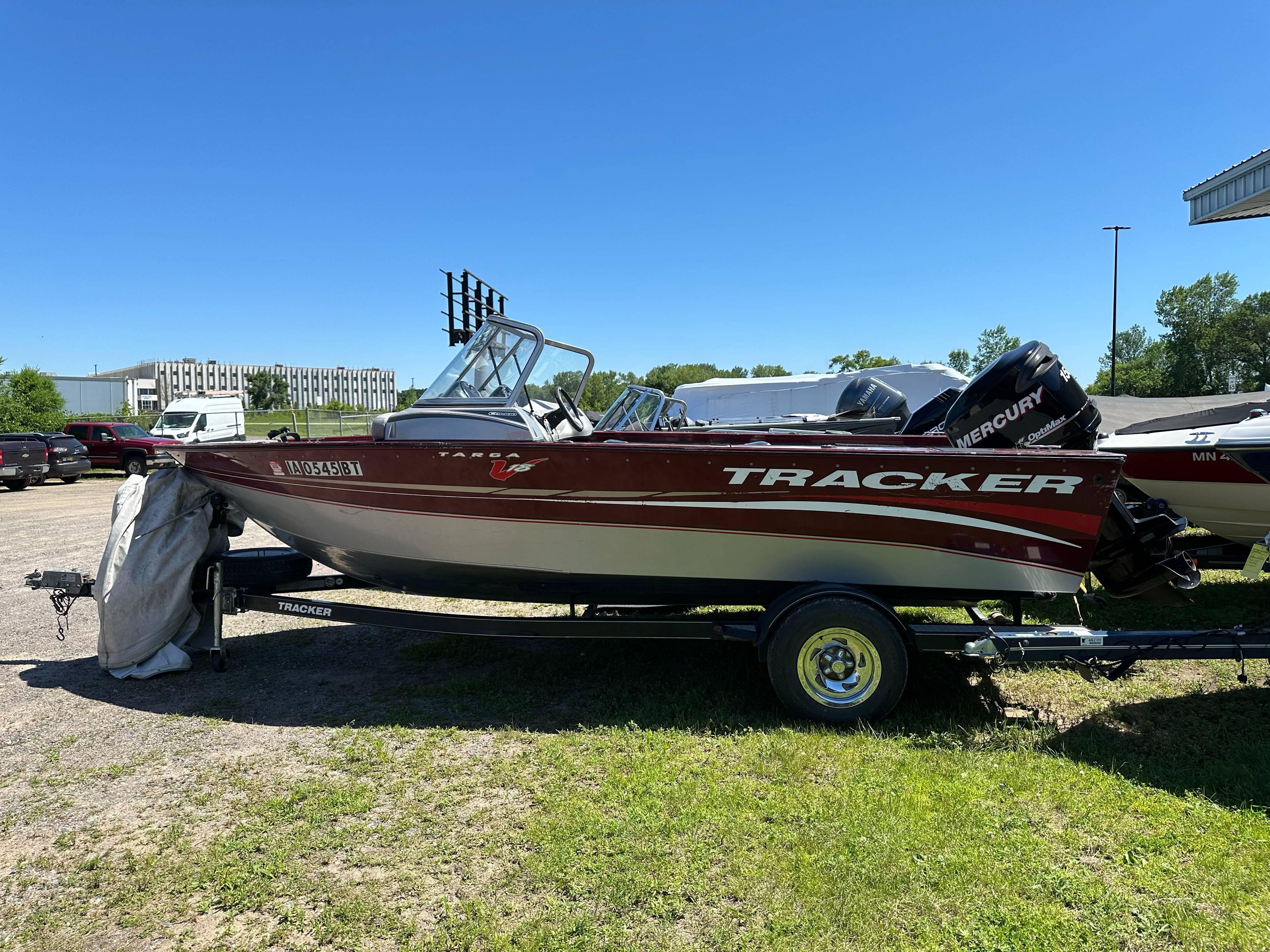 2011 Tracker Targa V-18 Combo boat on trailer, parked outdoors on grass.