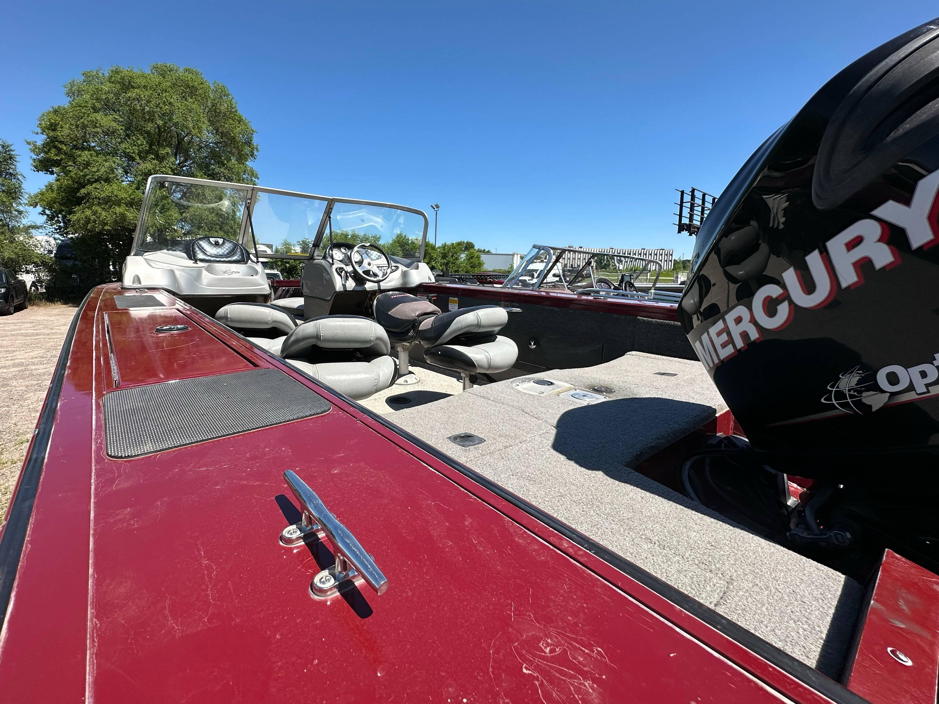 2011 Tracker Targa V-18 Combo boat with Mercury engine, red exterior, and spacious seating.