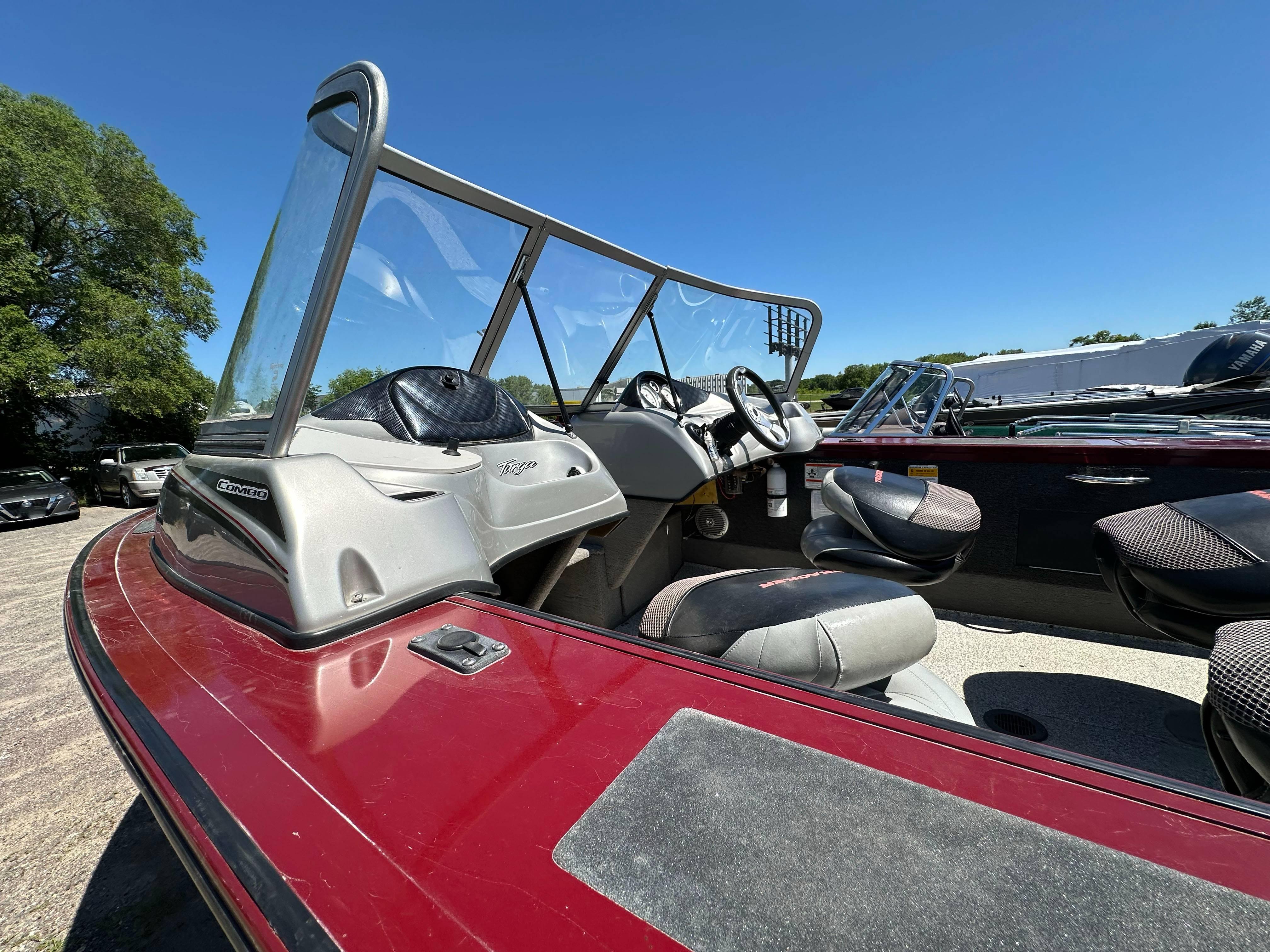 2011 Tracker Targa V-18 Combo boat with red exterior and spacious seating.